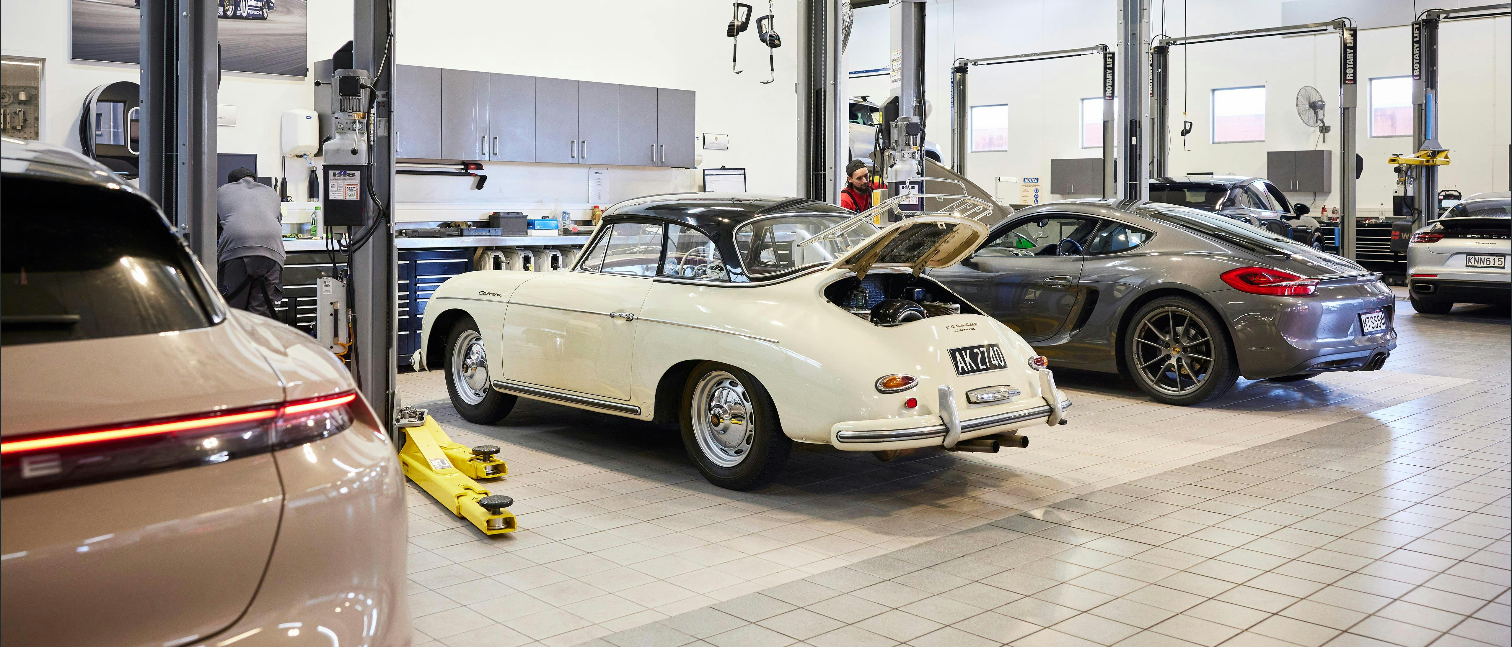 Mix of classic and modern Porsche models in service workshop