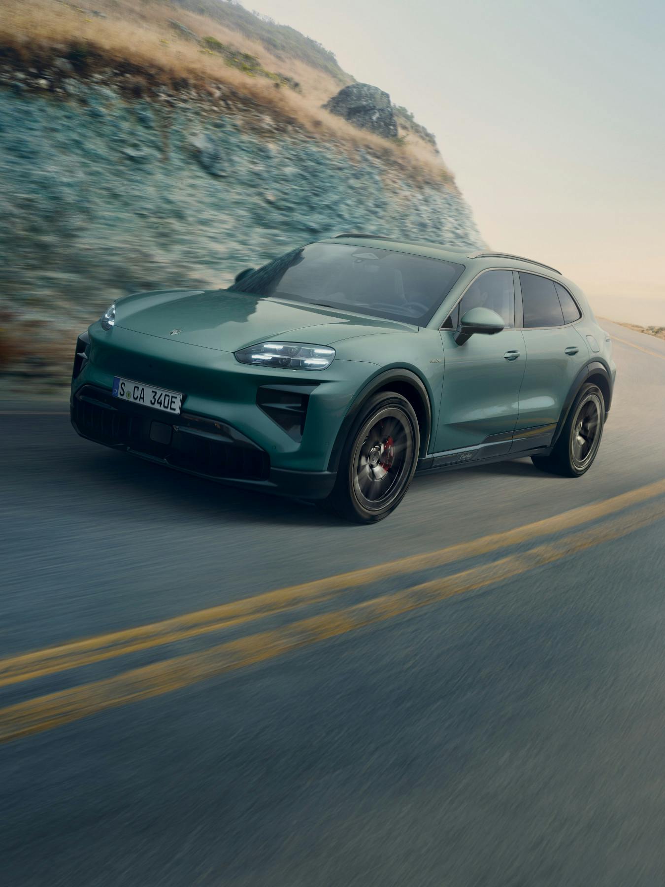 The Cayenne Turbo Electric driving along a road.