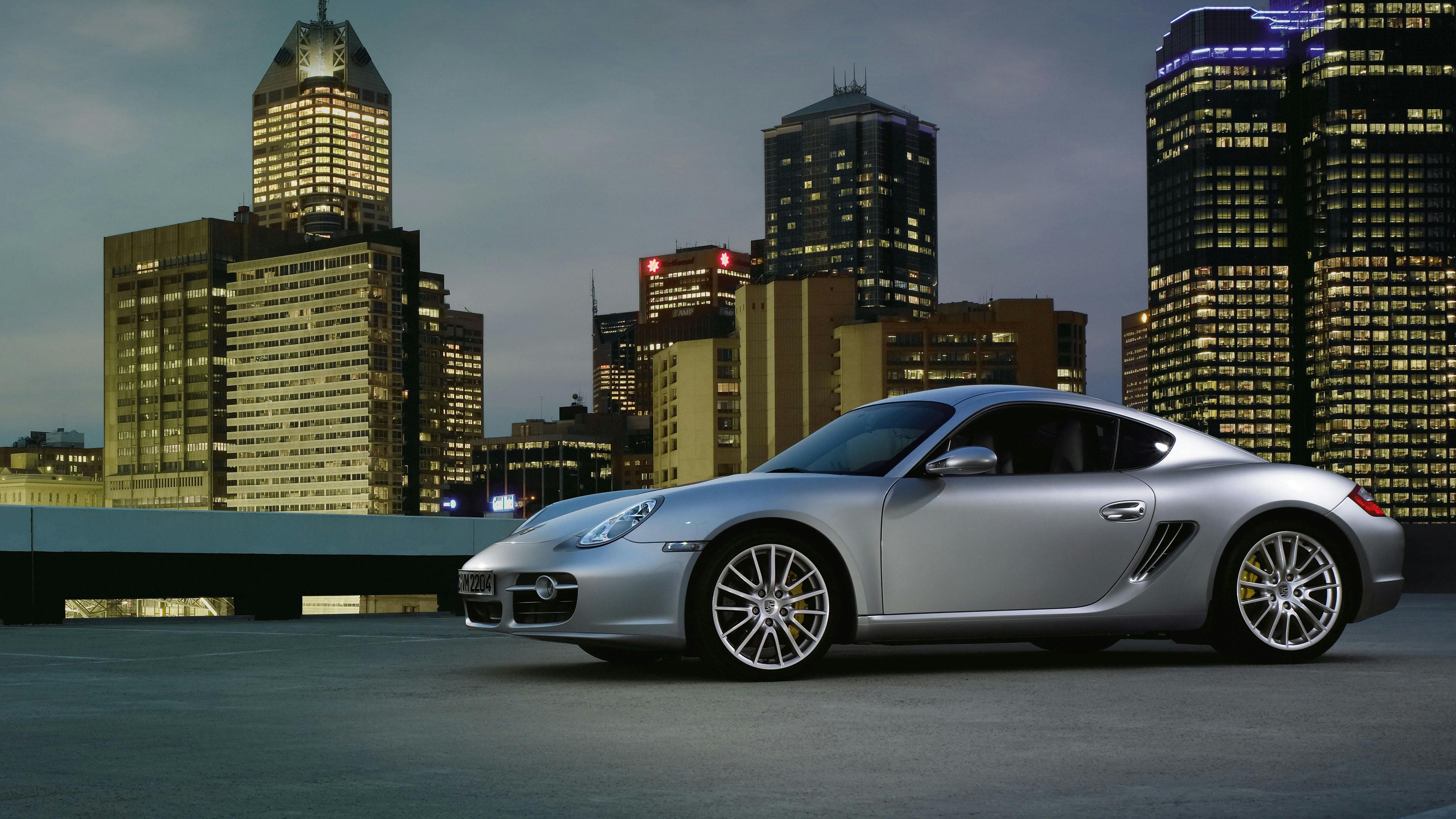 Silver Cayman S of the type 987 on a car park in an urban environment.