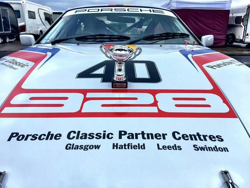 The Silverstone Finals trophy standing on the bonnet of the Porsche 928.