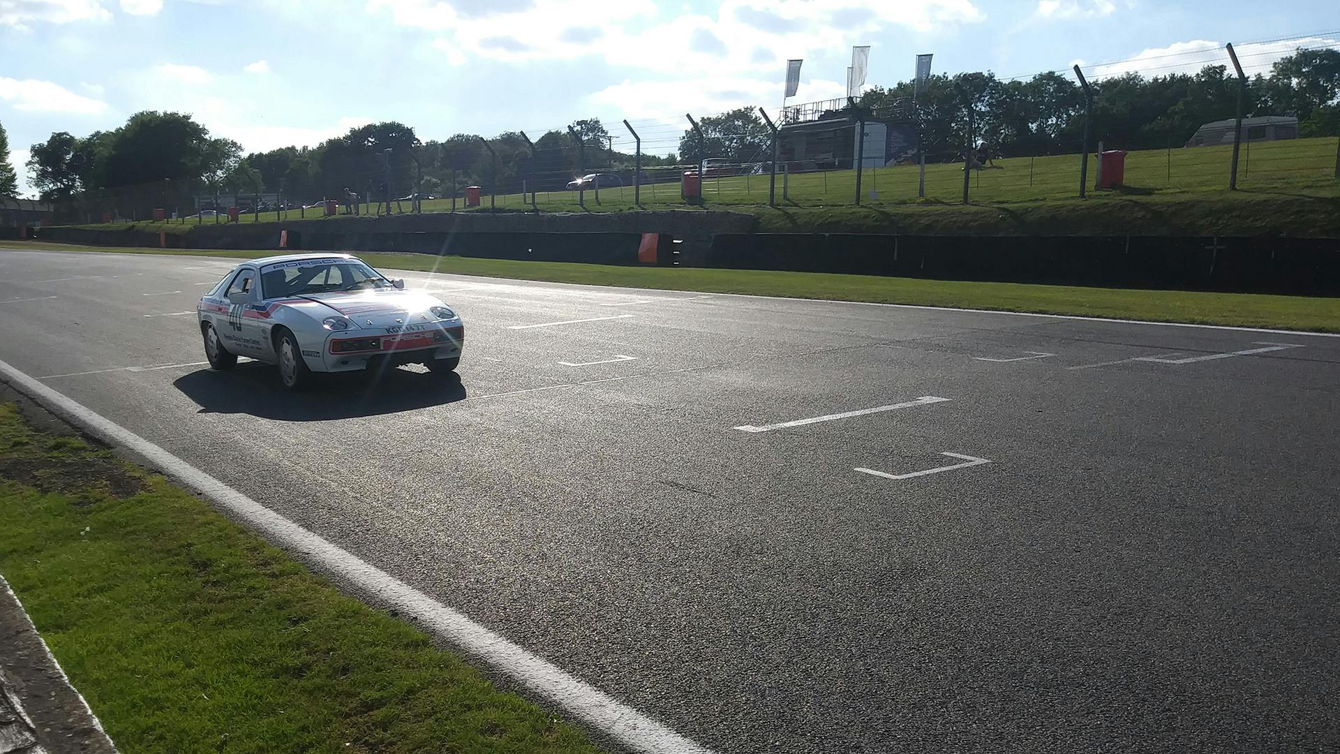The Porsche 928 racing along the race track.