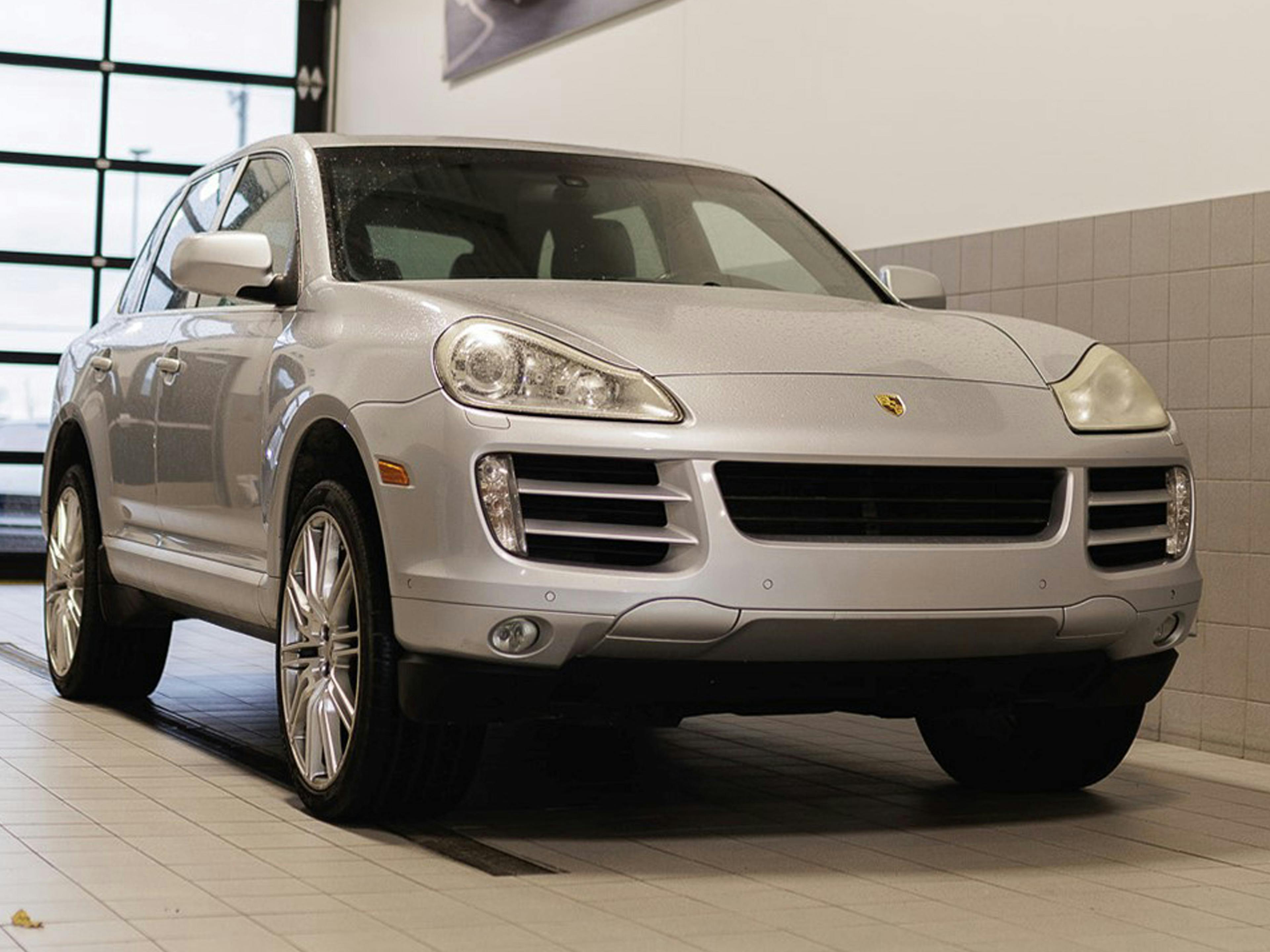 Lauzon – A silver Porsche Cayenne showcased inside a service bay with tilted flooring.