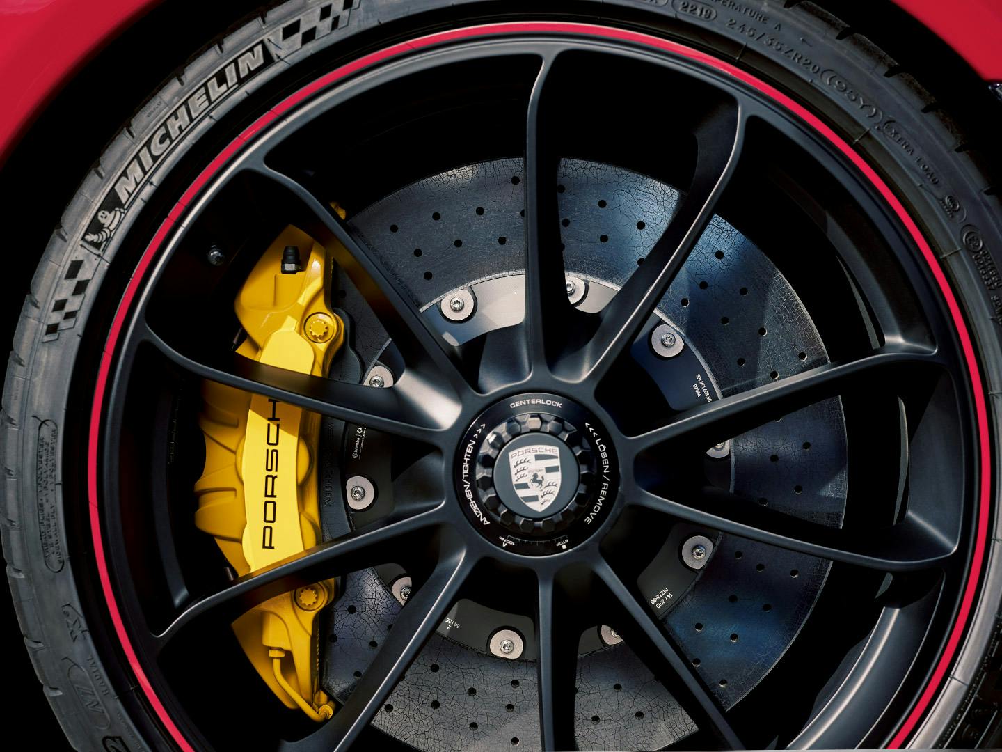 A close-up of the wheel. You can see a Porsche ceramic brake with yellow-coated aluminium fixed callipers.