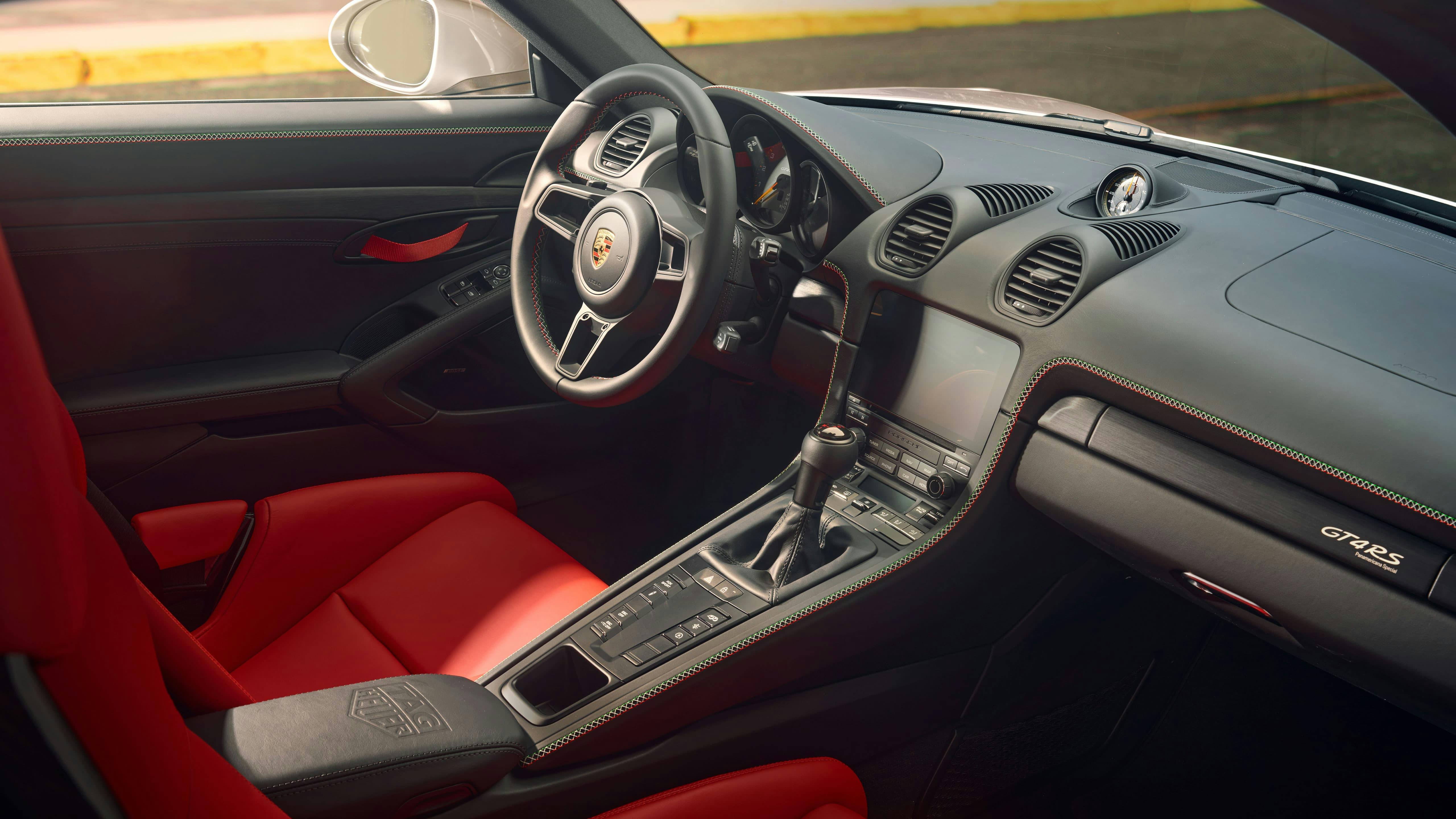 A stunning center console with black, green, white, and red stitching.