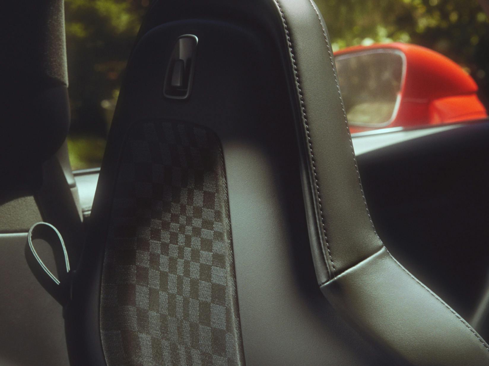 Detailed view of the decorative inlays on the seat backrest of a Porsche with Heritage Design Package Pasha.