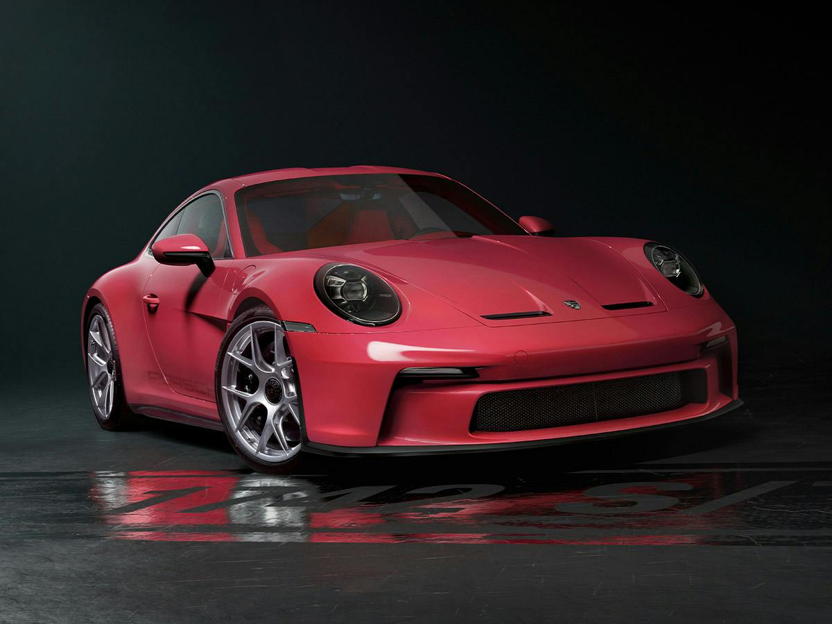 911 S/T in Paint to Sample Plus colour Rosered, shown from a low front angle in a dark studio setting.