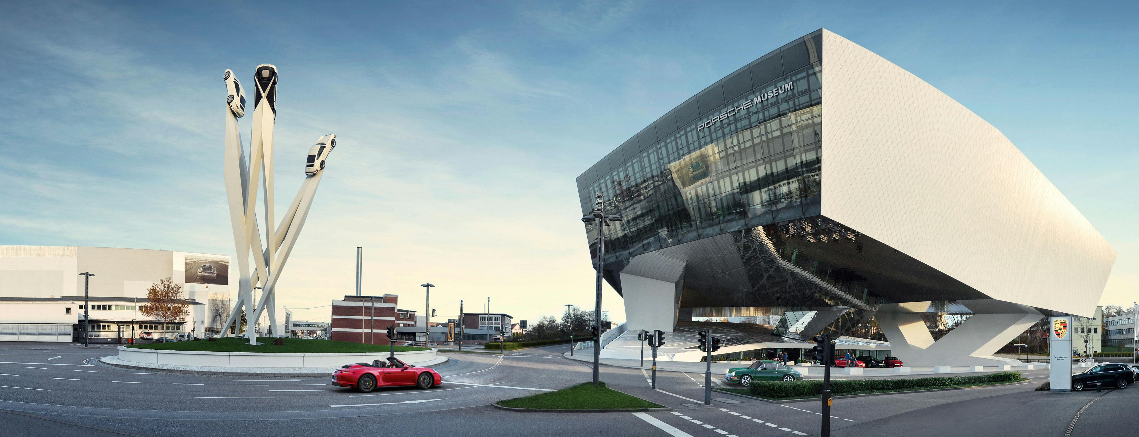The exterior view of the Porsche Museum in Stuttgart with the Porsche sculpture in front of the museum