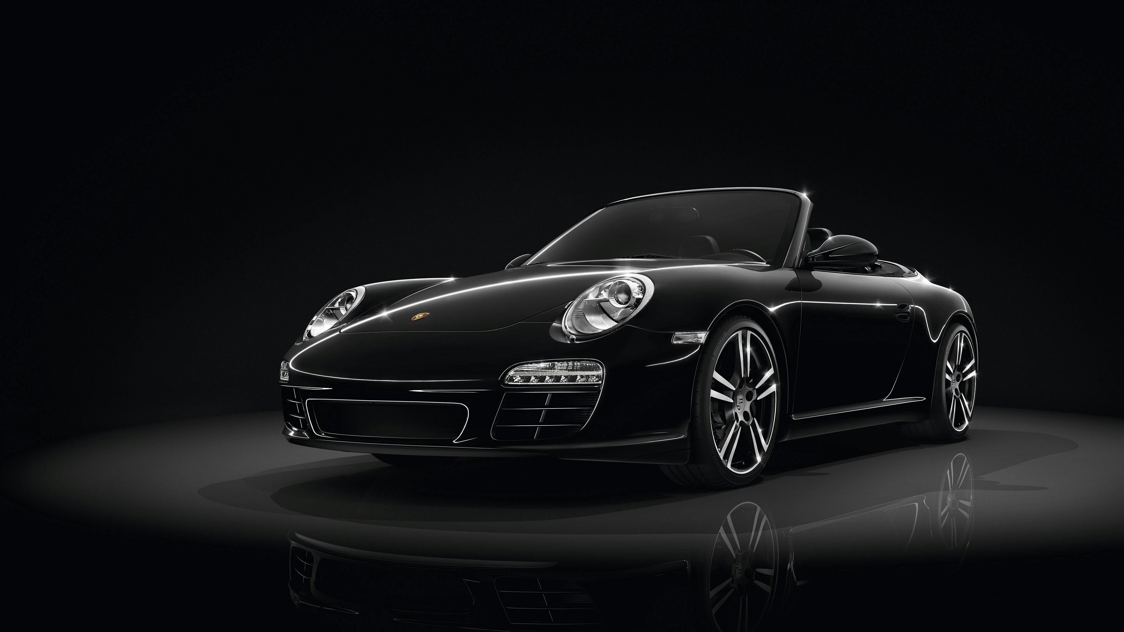 Black 911 Black Edition Cabriolet in the studio on a dark background.