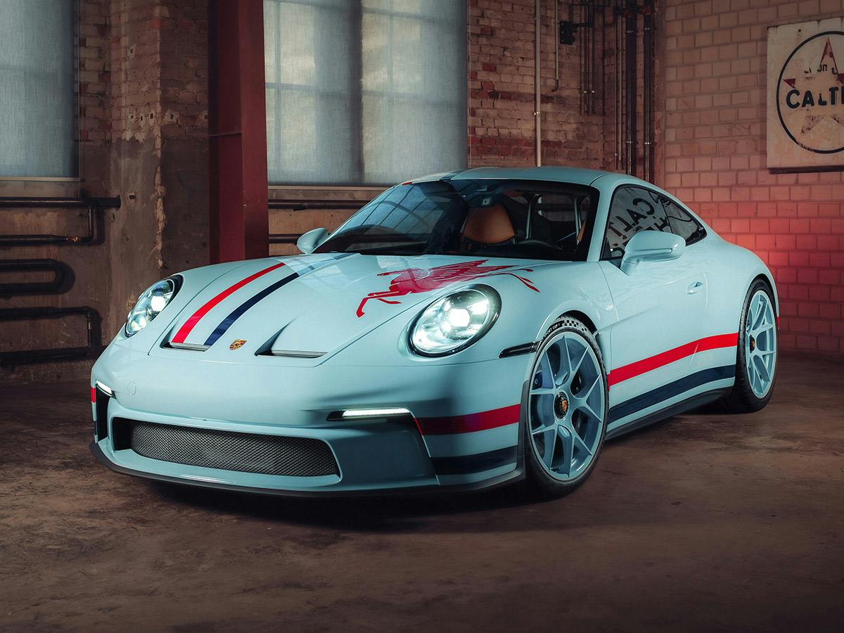 Front view of a 911 S/T in Paint to Sample Plus colour Coppaflorio, parked indoors with large industrial windows in the background.