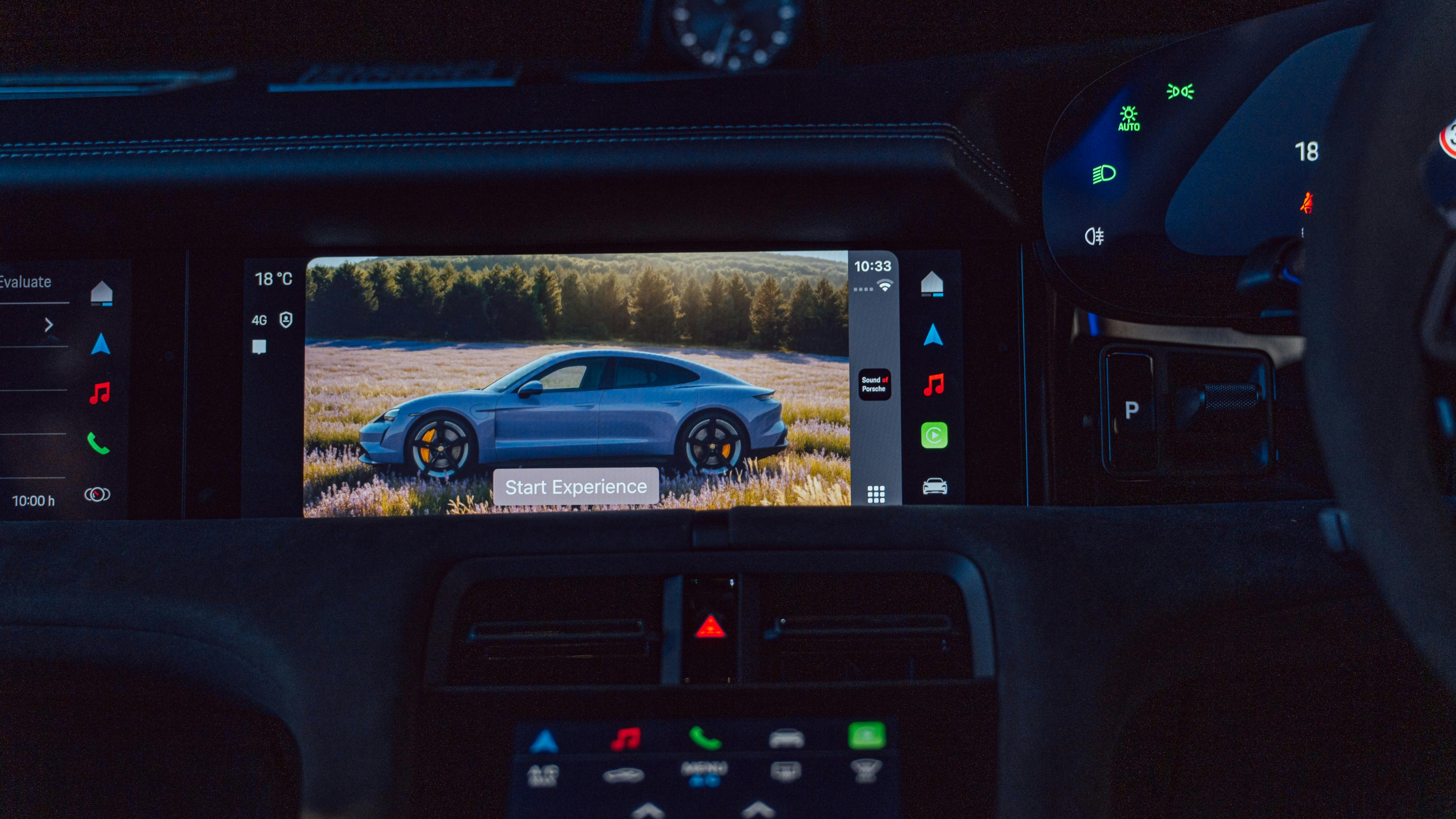 The interior display dashboard showing a Porsche Taycan on the home screen.