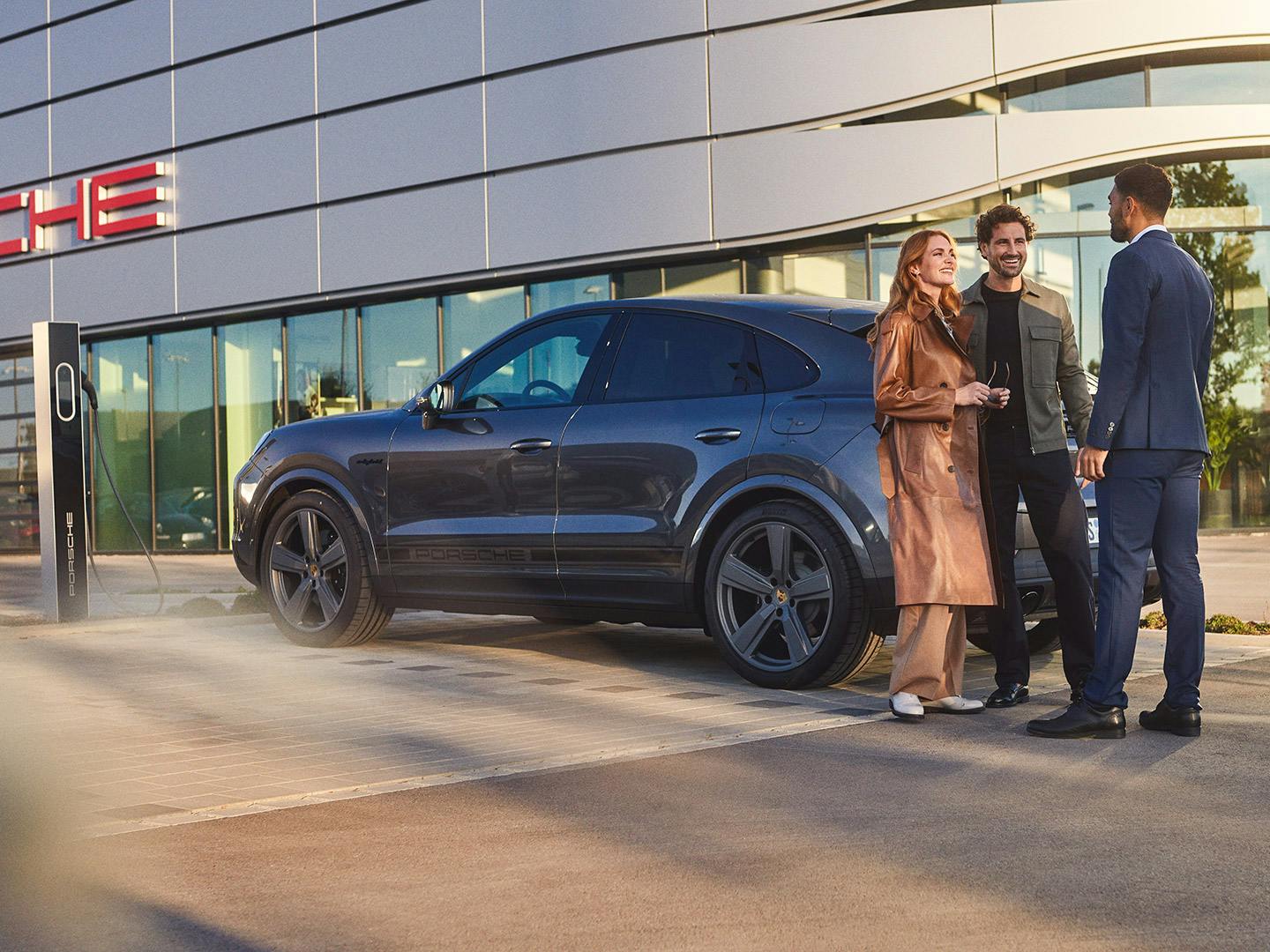 Family and Porsche employee standing outside Porsche Centre