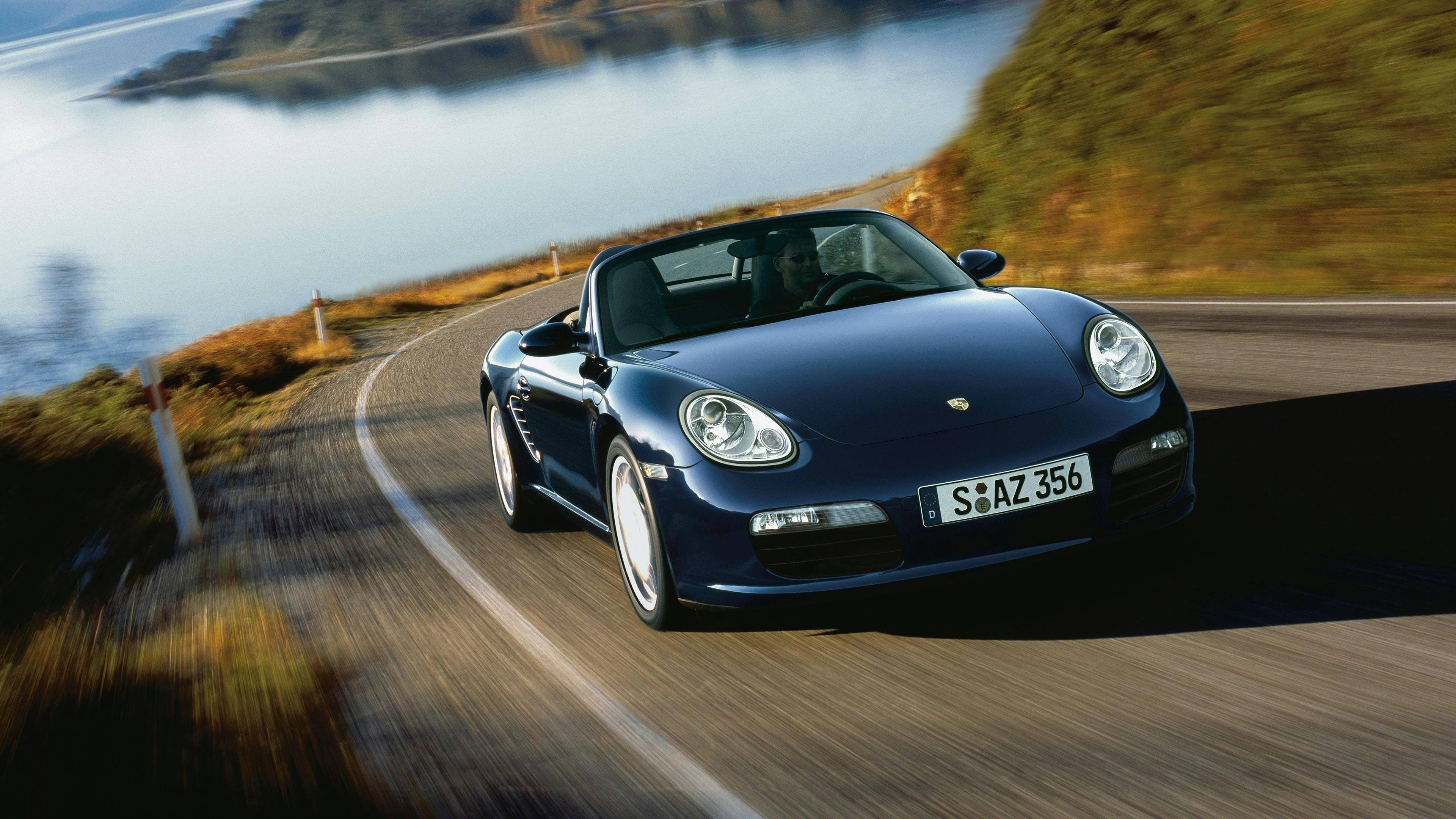 Blue Boxster of the type 987 on an moutain road.
