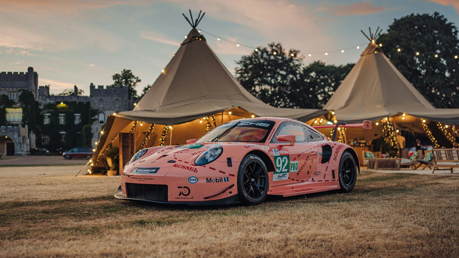Liveried Porsche race car parked at Goodwood Festival of Speed.