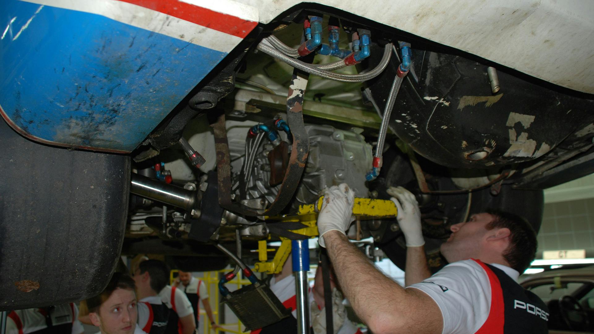 Employee removing the engine of the Porsche 924 GTP.
