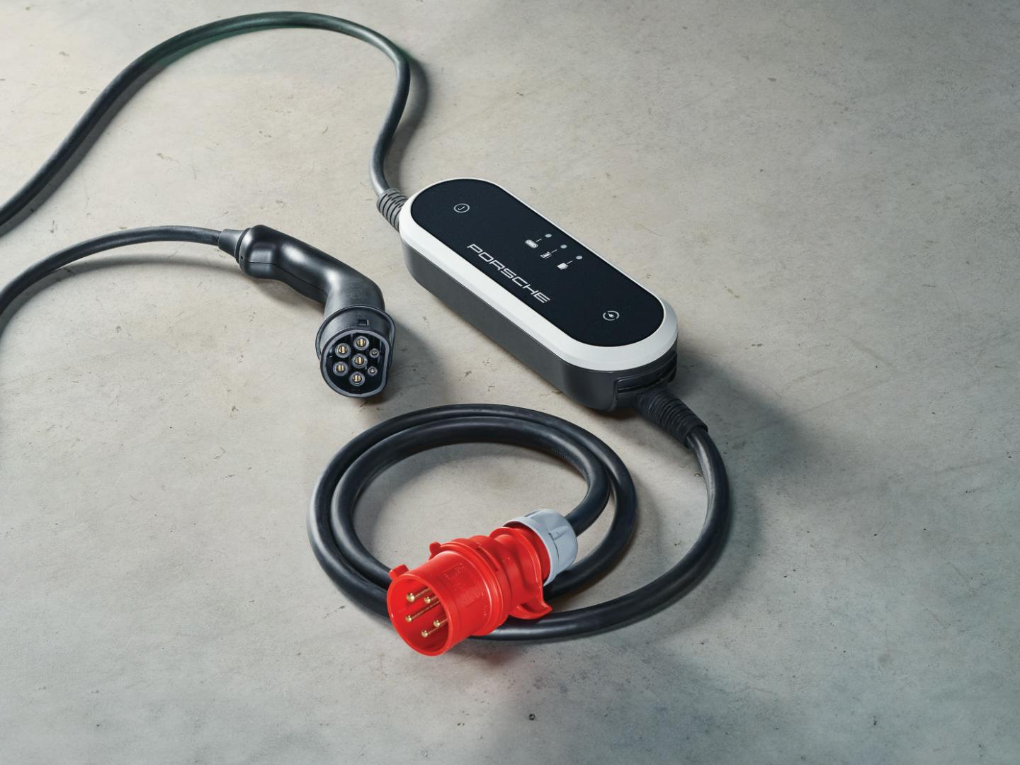 Illustration of the Porsche Mobile Charger Plus mobile charger against a grey background.
