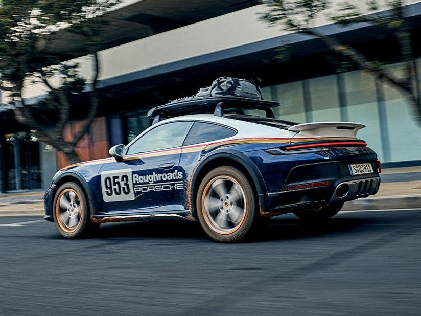 Left rear view of Porsche 911 Dakar with Rally Design Package and roof basket with accessories.