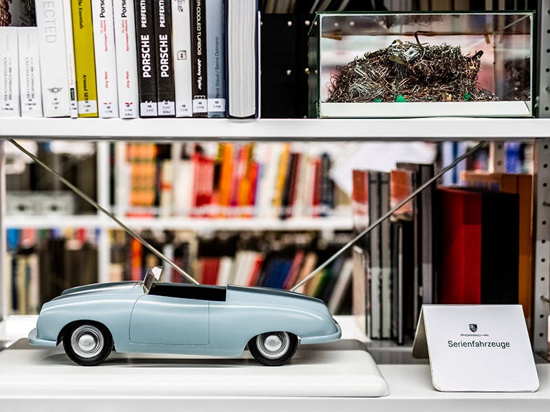 Miniatur Modelle von Porschefahrzeugen auf weißen Schränken im Archiv des Porsche Museums