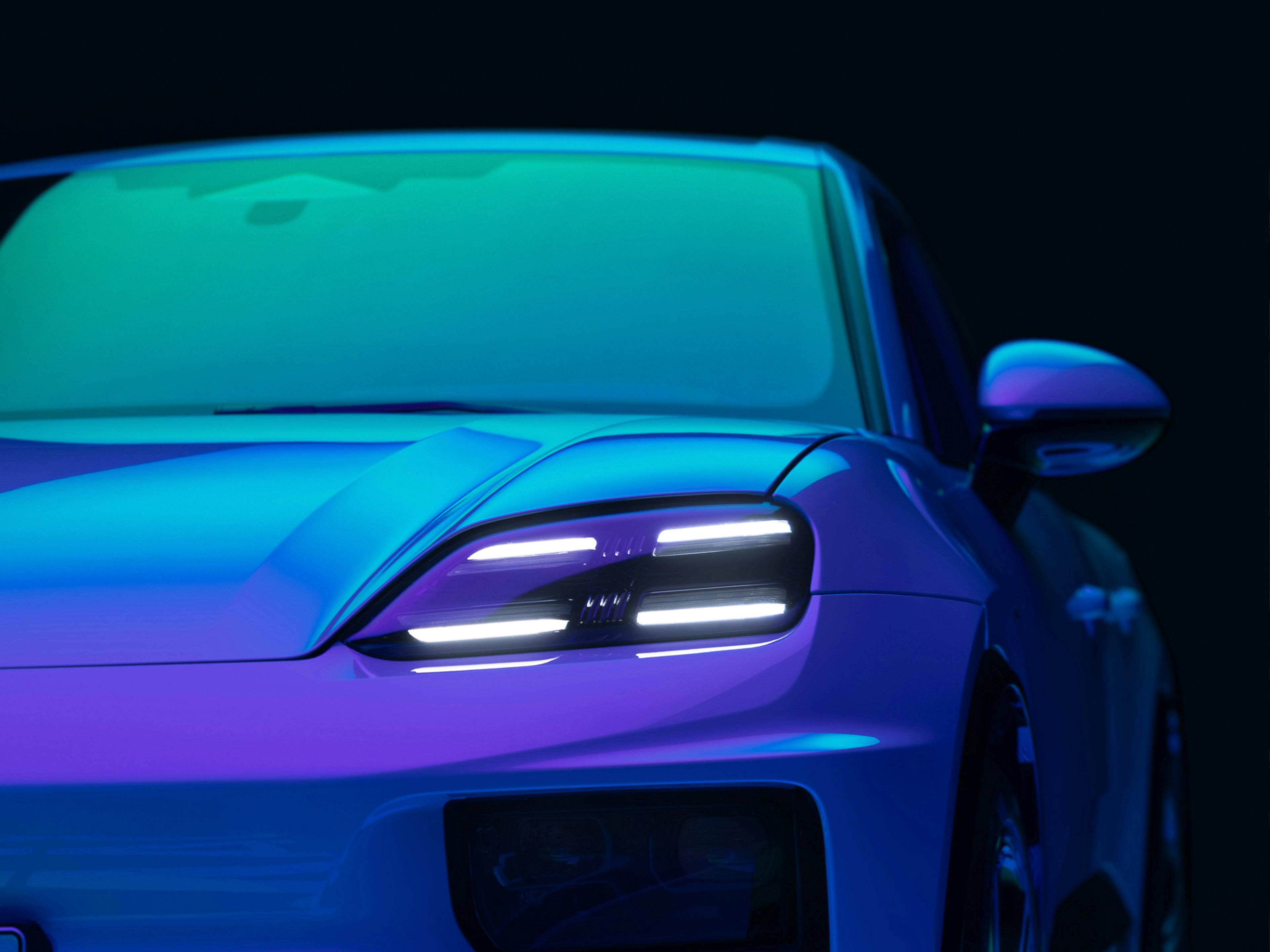 Front quarter of Porsche Macan in vibrant studio lighting.
