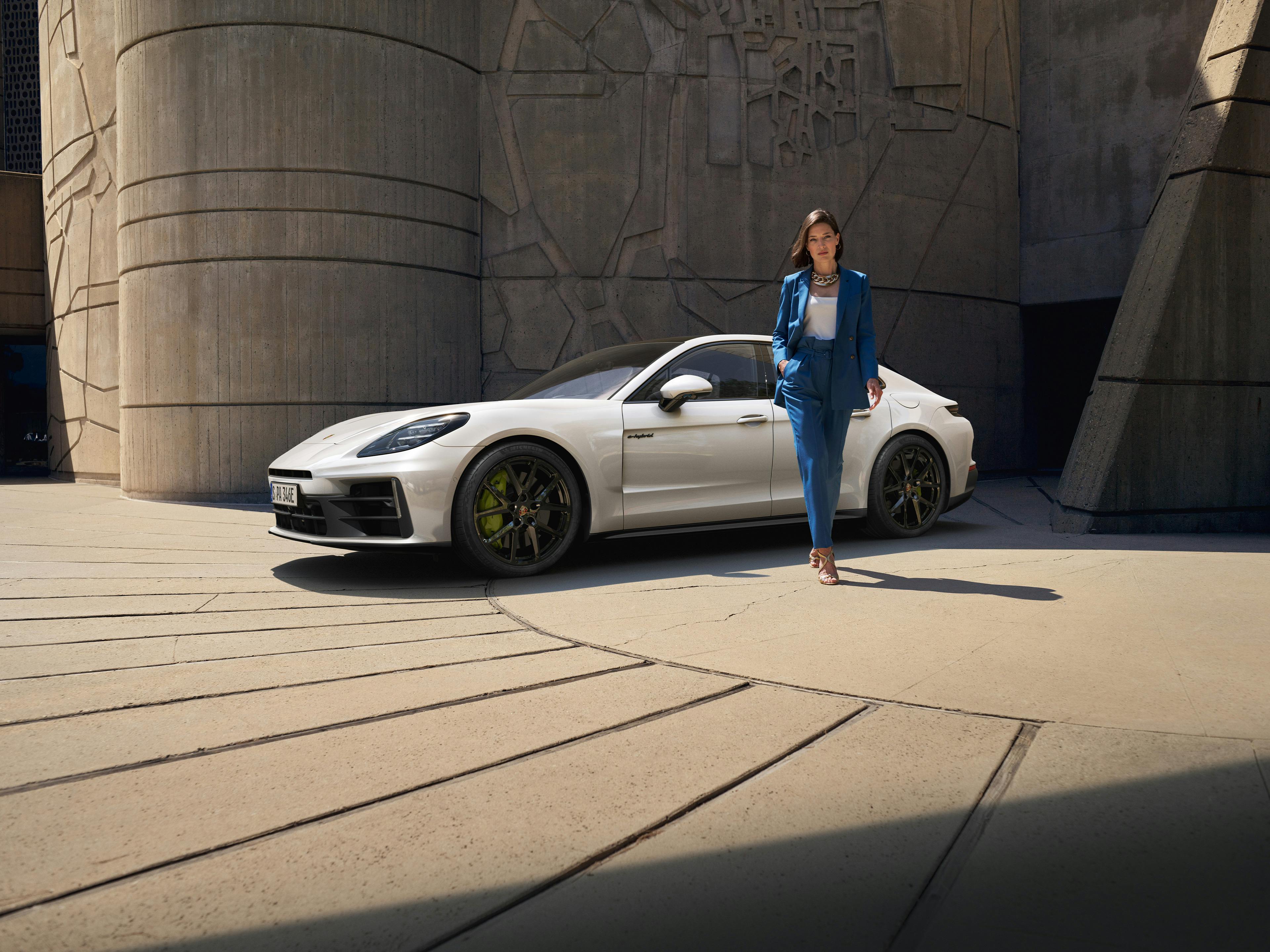 Panamera parked, while lady walks way.