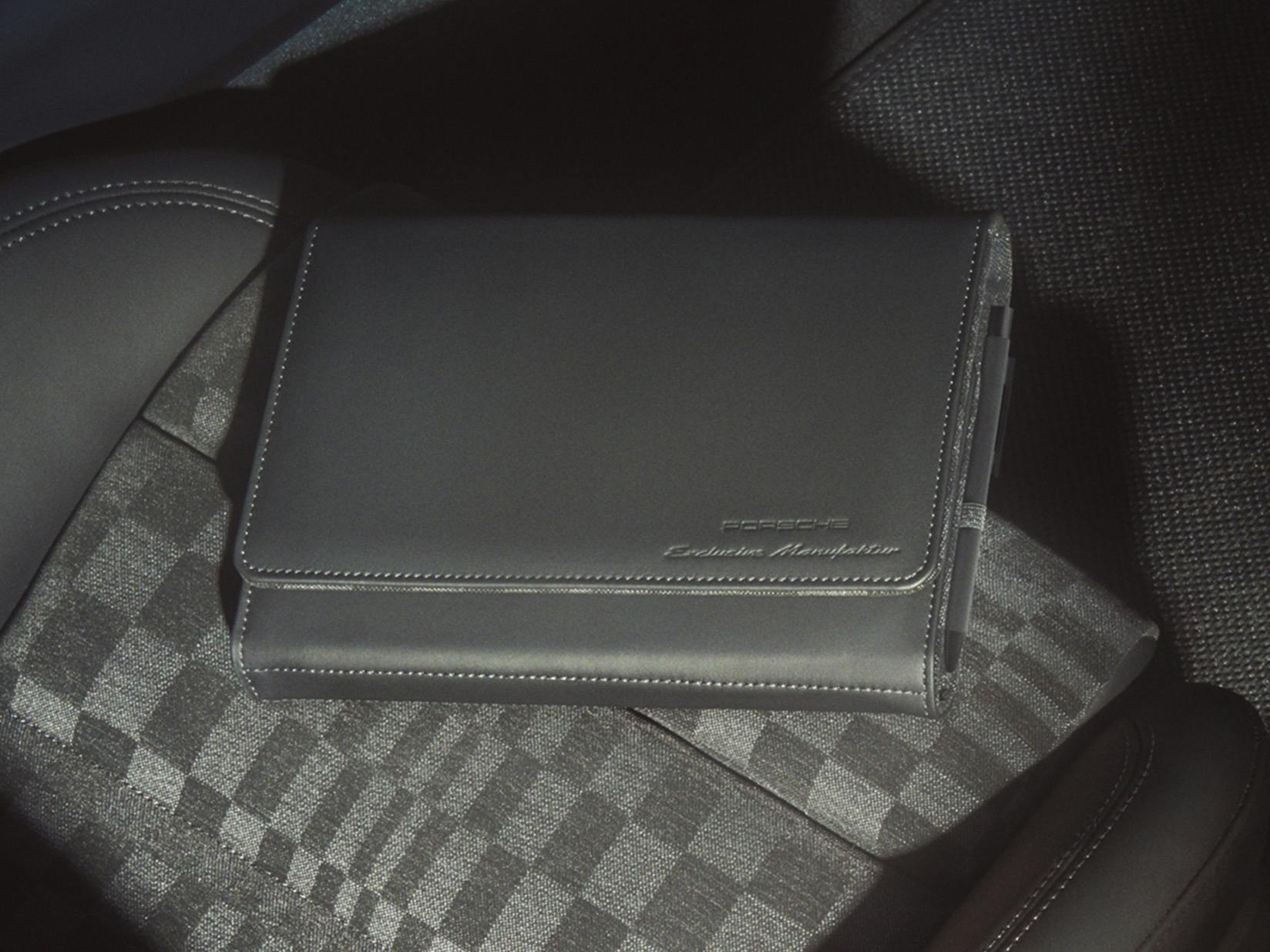 View of a Porsche documentation folder made of Black leather.