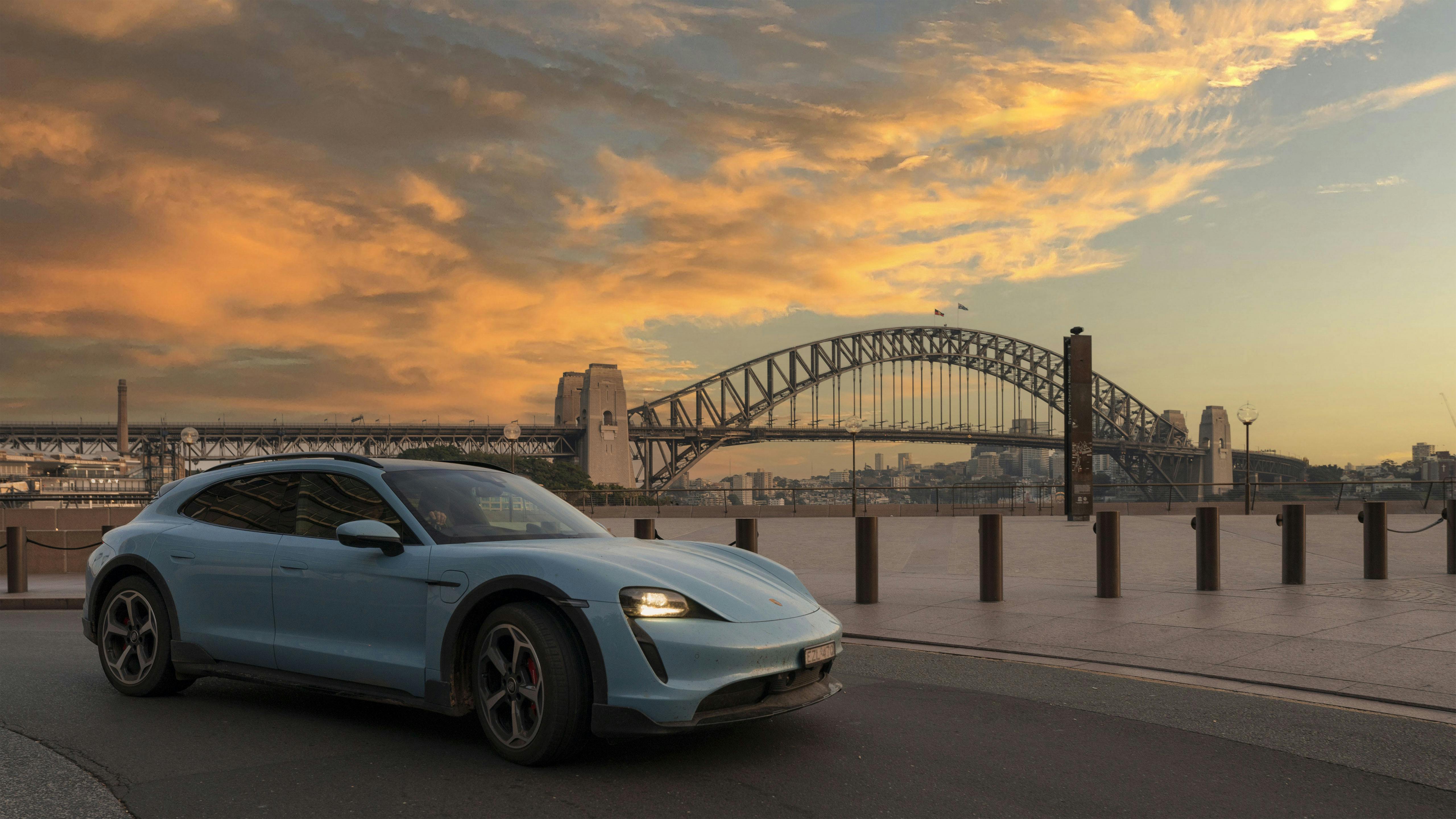 Porsche Taycan with cityscape backdrop