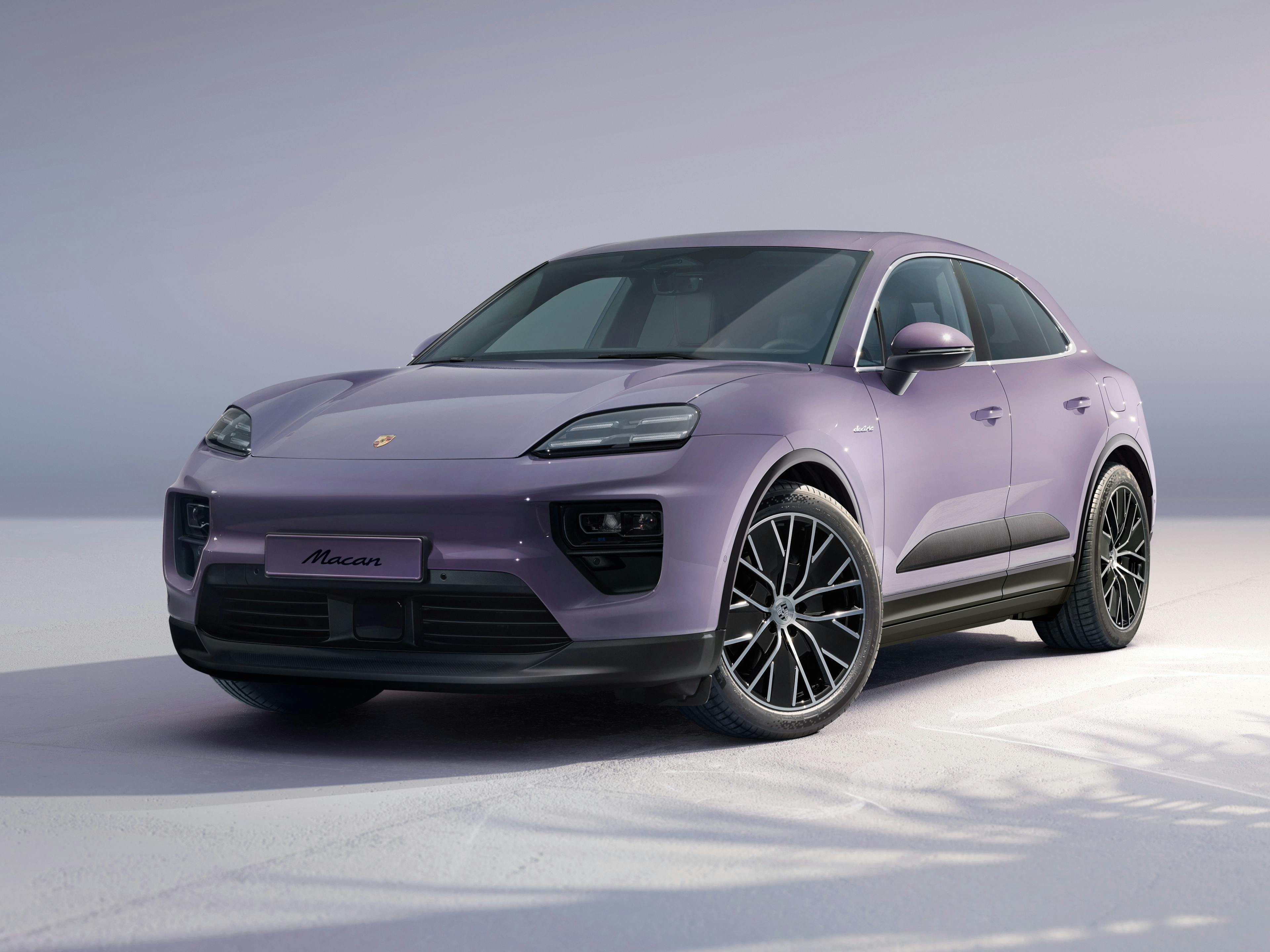 Macan 4 Electric parked in a studio, angled towards the front.