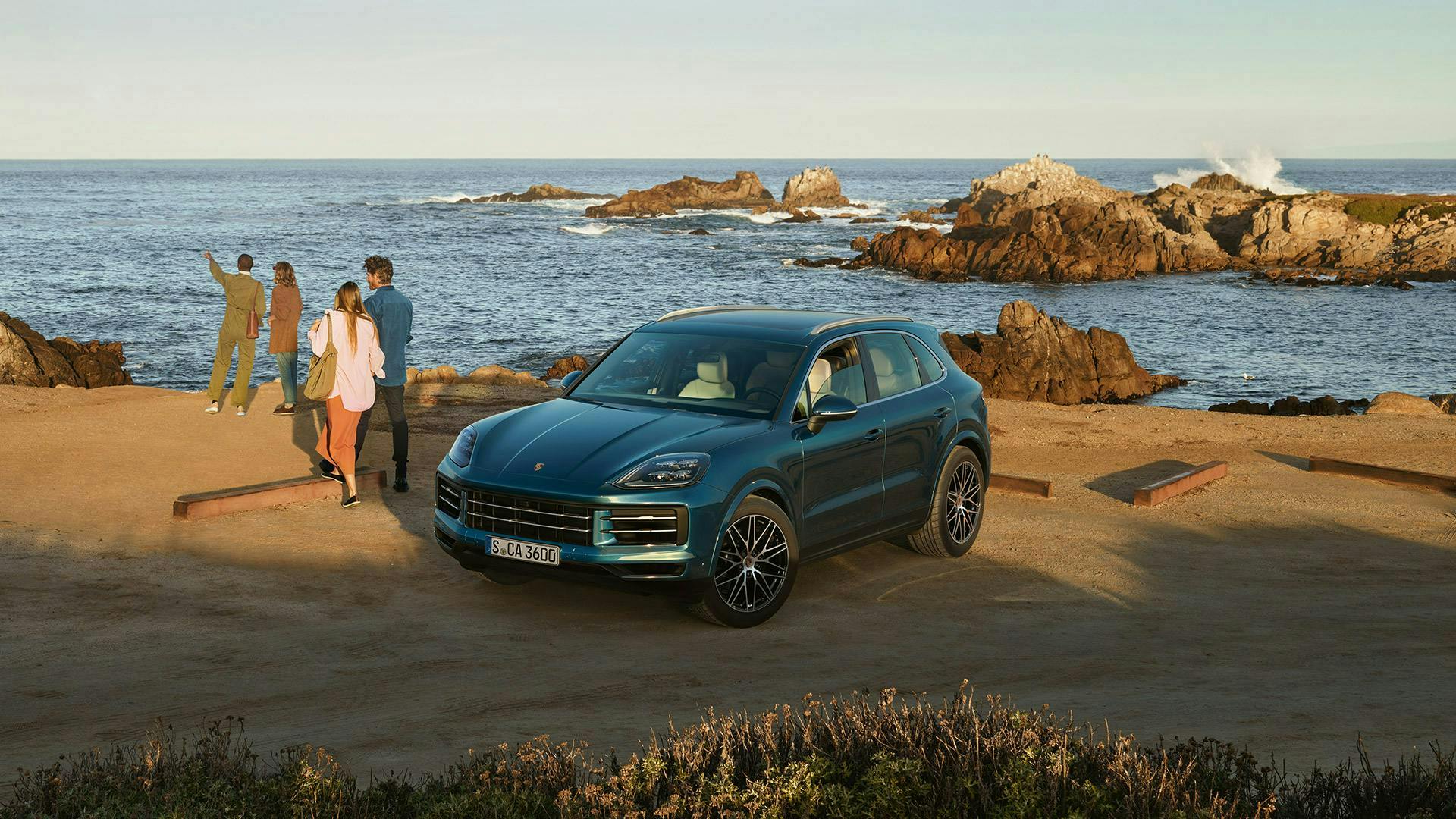Porsche SUV and passengers on a beach landscape