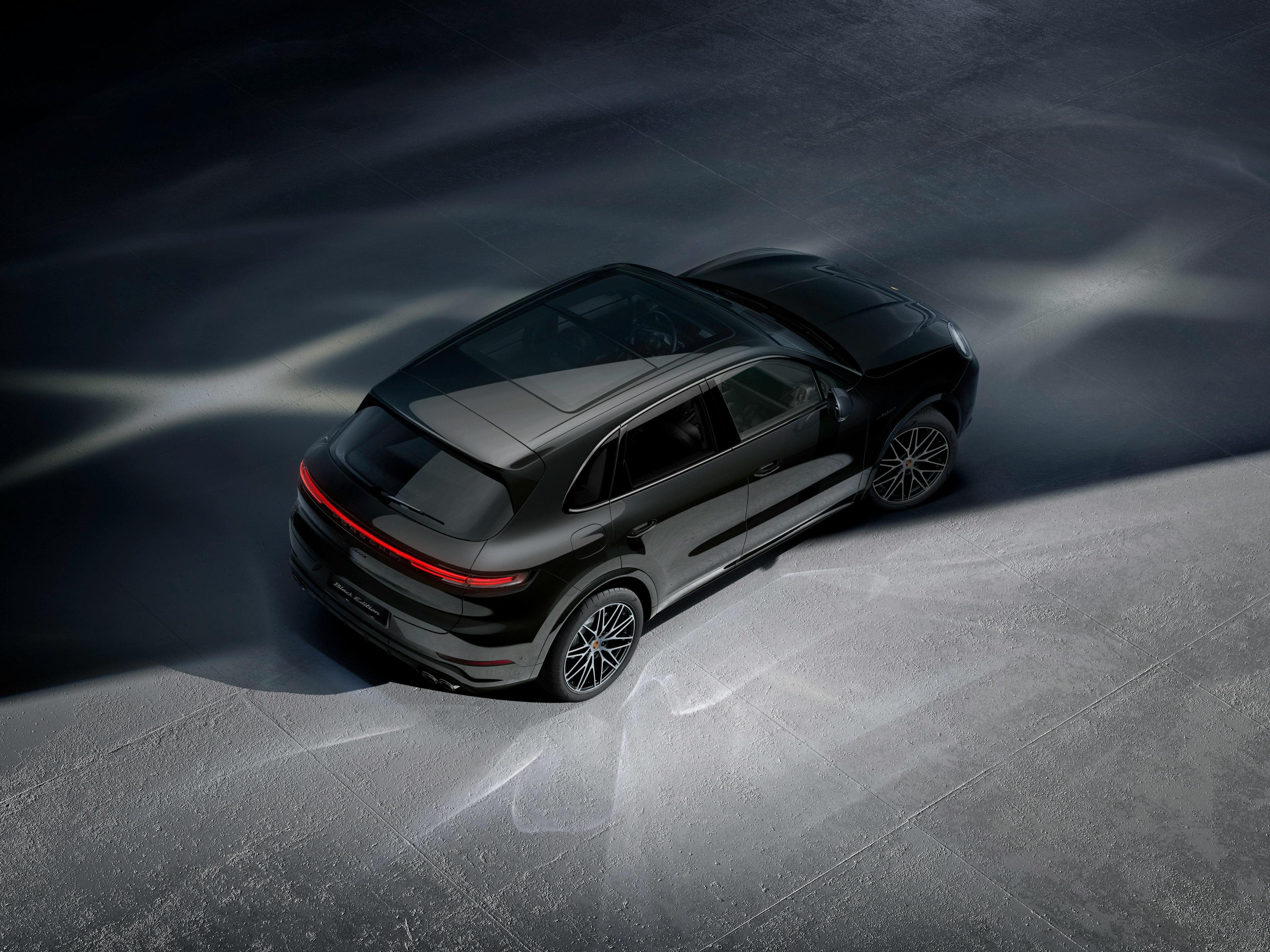 The Cayenne E-Hybrid Black Edition seen from an aerial view, parked in a studio.