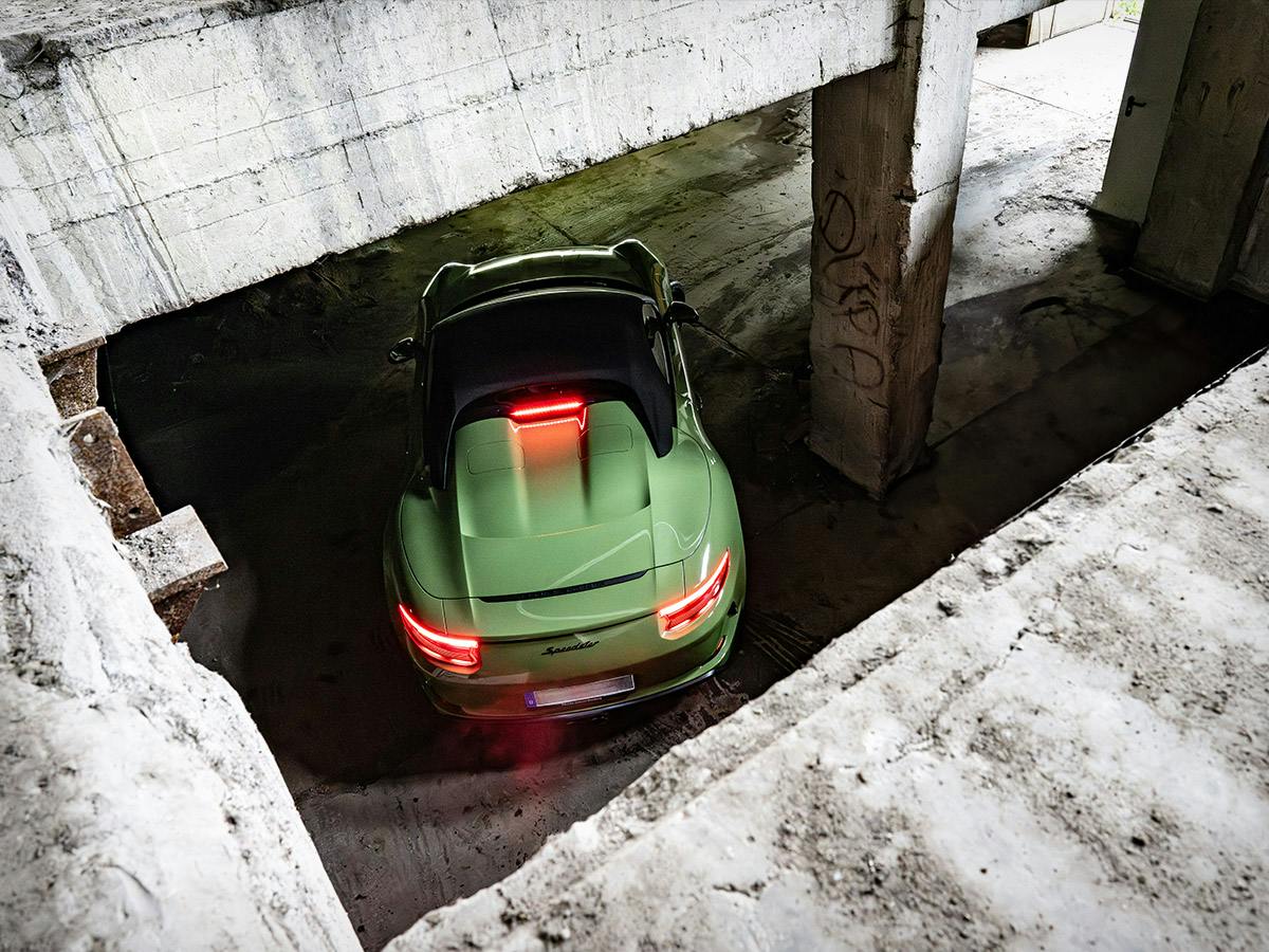 A 911 Speedster coloured in Olivegreen from above in an old factory.