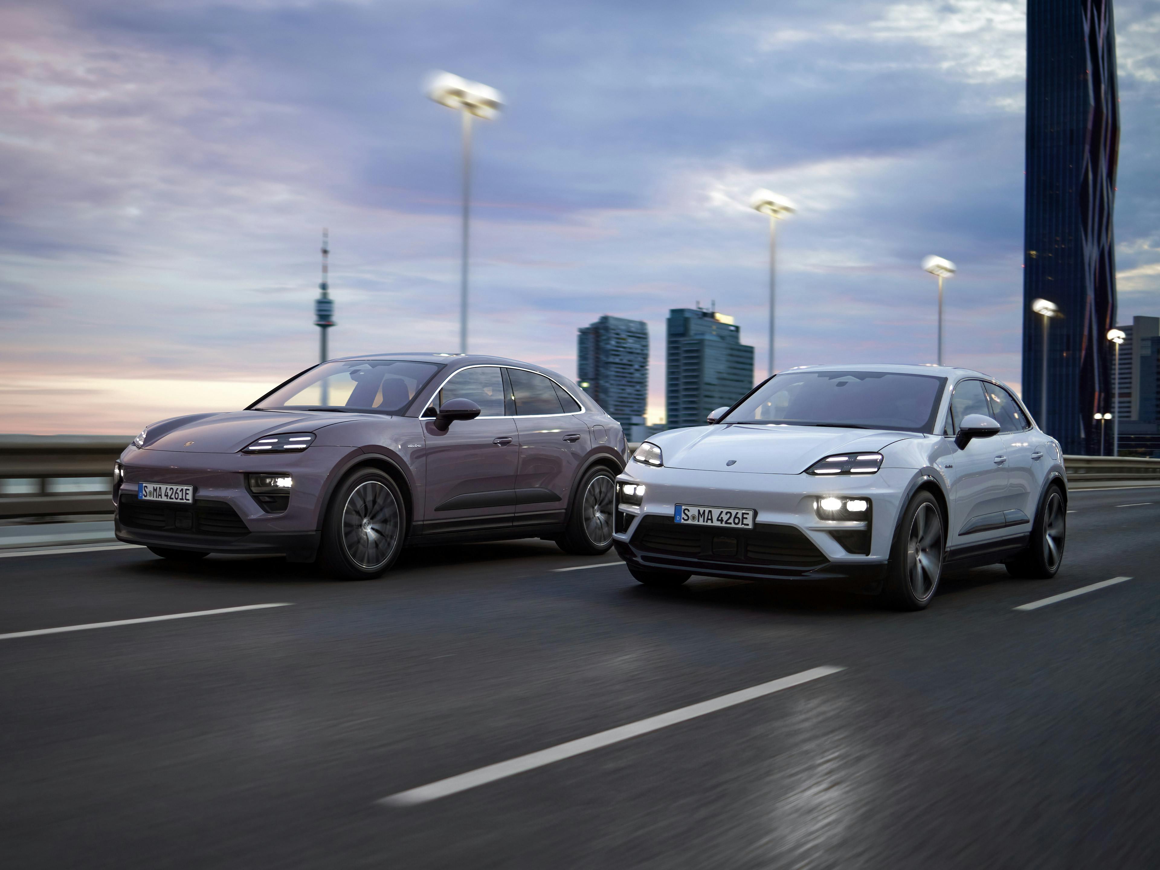 Provence Macan and white Macan driving on a highway at dusk.