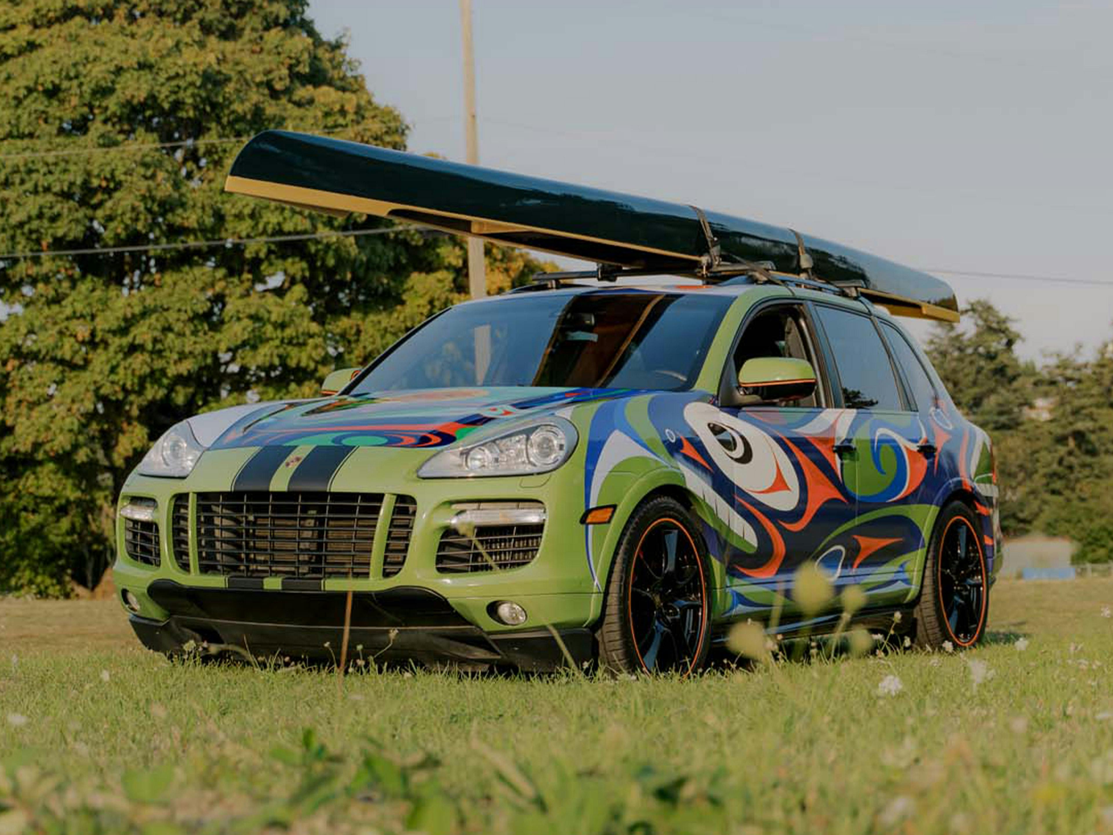 Victoria – A black Porsche Cayenne pictured from the side in a workshop.