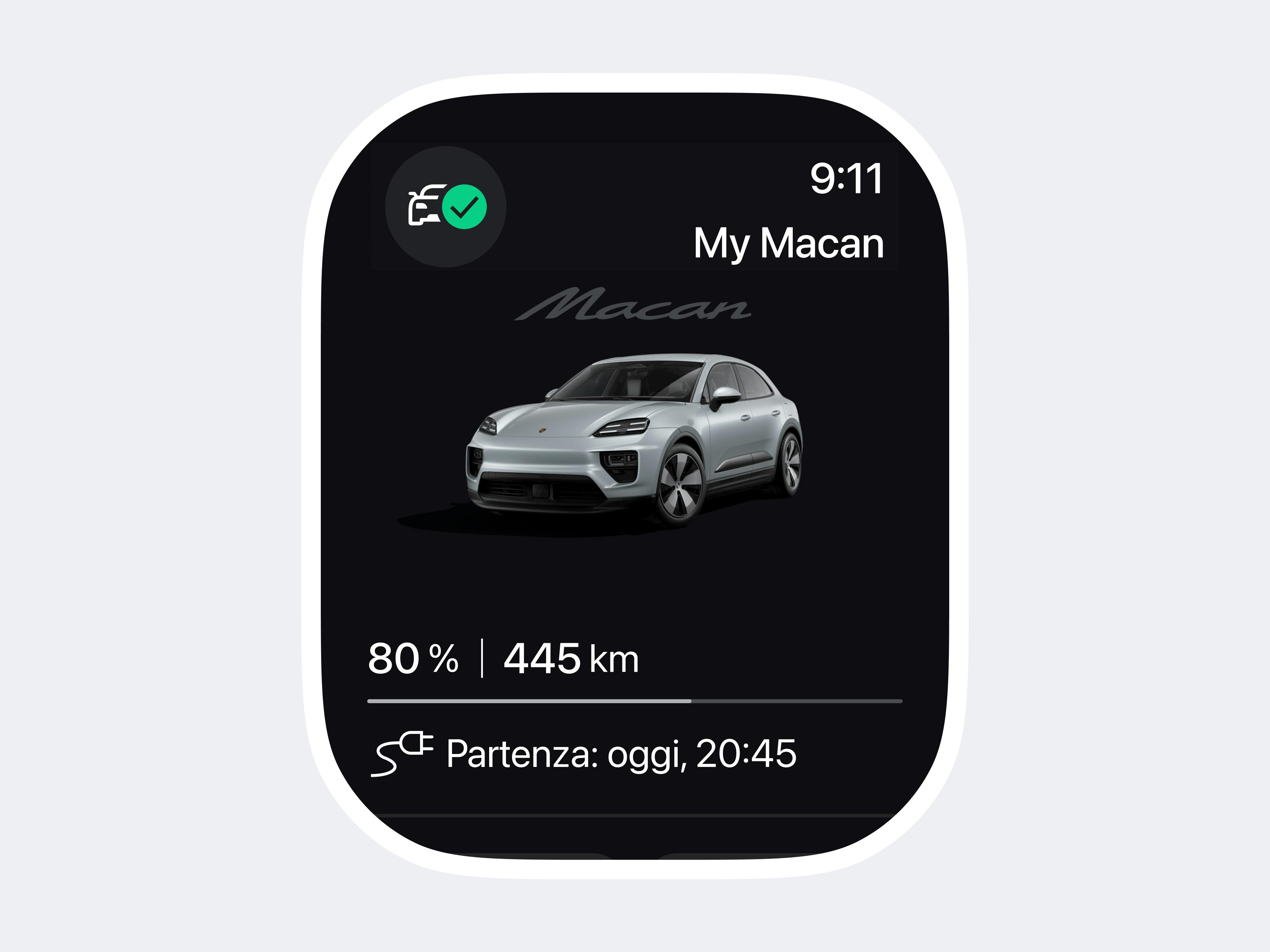 Il display dello smartwatch mostra una Porsche Macan argentata con informazioni sul livello di carica e l'ora di partenza su una schermata scura dell'app.