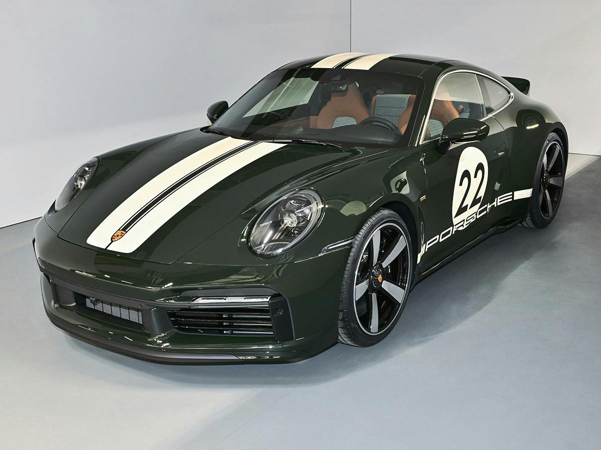A Porsche 911 Sport Classic (992) in Paint to Sample colour Brewstergreen, shown from a three-quarter front view, featuring Lightivory double stripes on the bonnet and roof and a historic ‘22’ race number on the door.