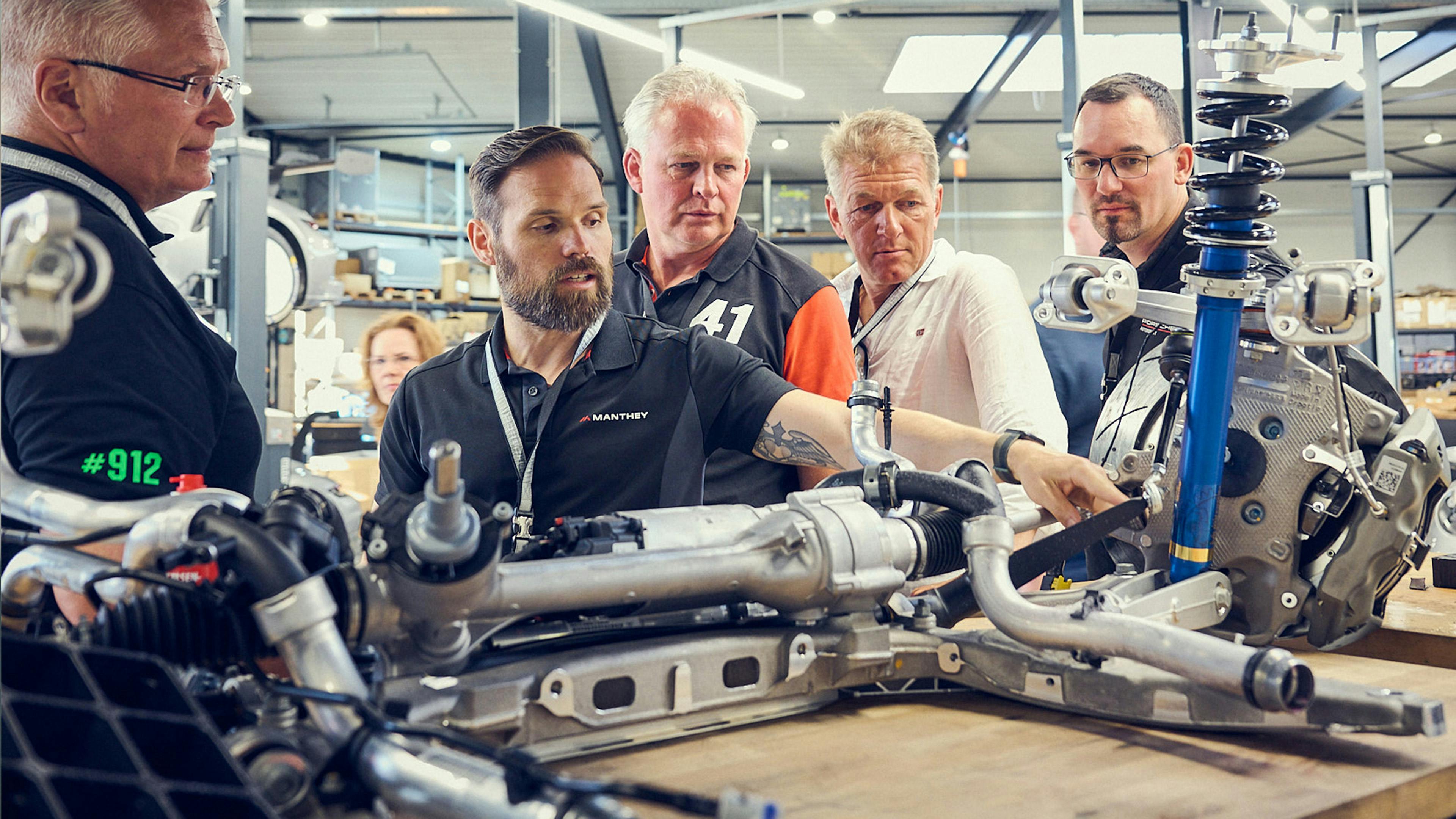 Porsche fans working on an engine