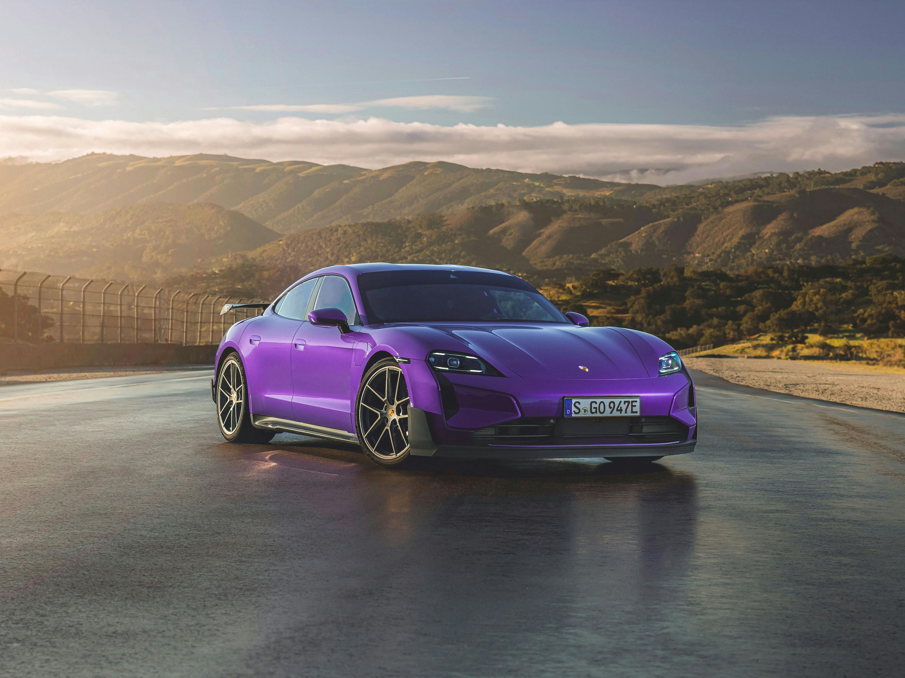The Taycan Turbo GT with Weissach Package in purple parked in an outdoor scenic location.