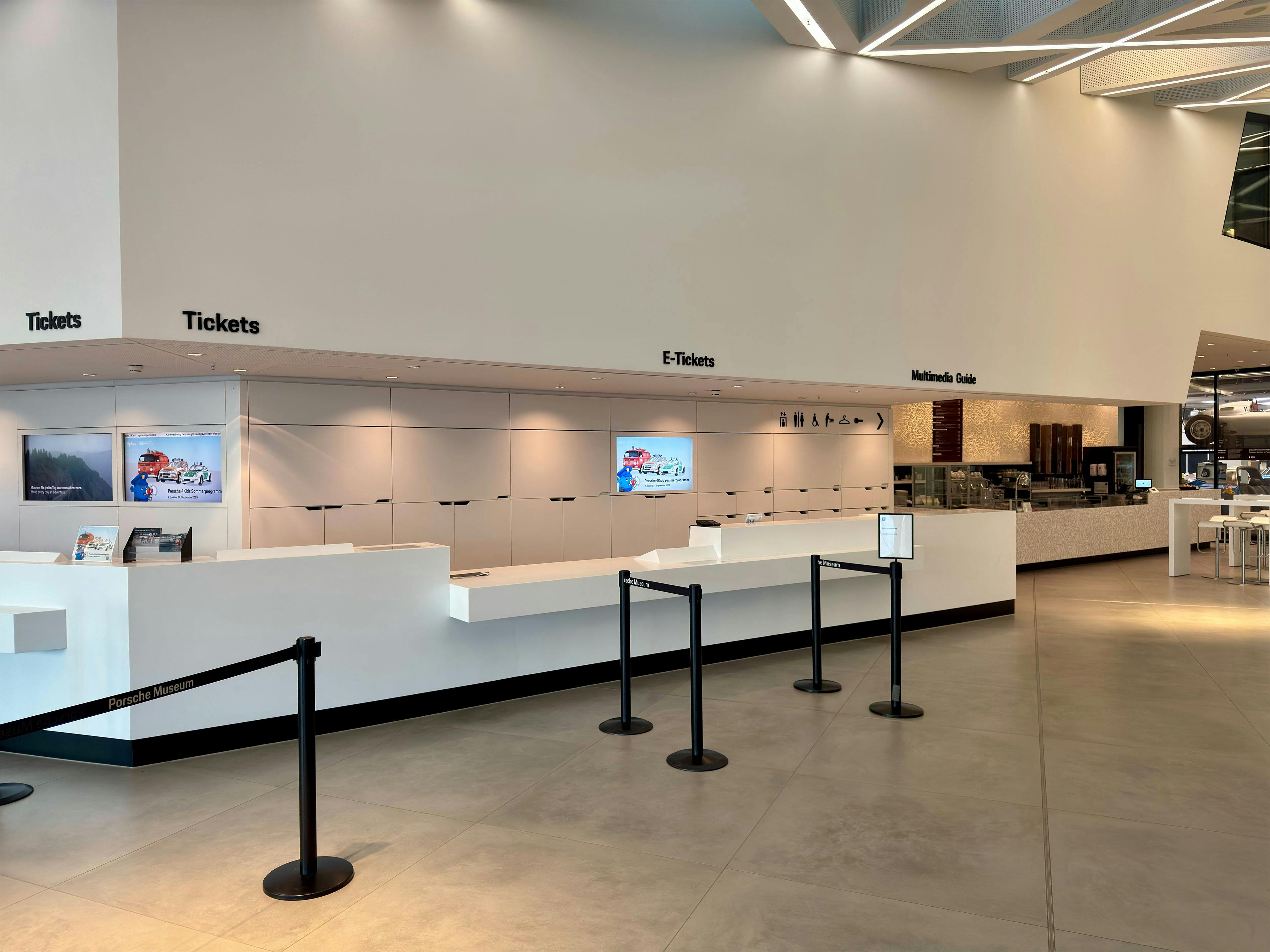 Modern ticket counter area with sections for “Tickets”, “E-Tickets” and “Information Desk”, featuring digital screens and clear visitor guidance.