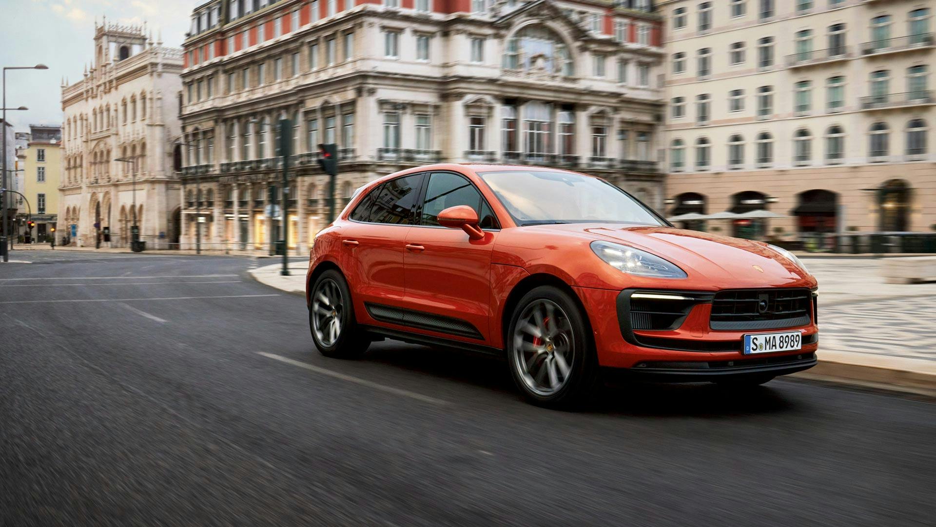 Porsche Macan S driving in classy urban environment.