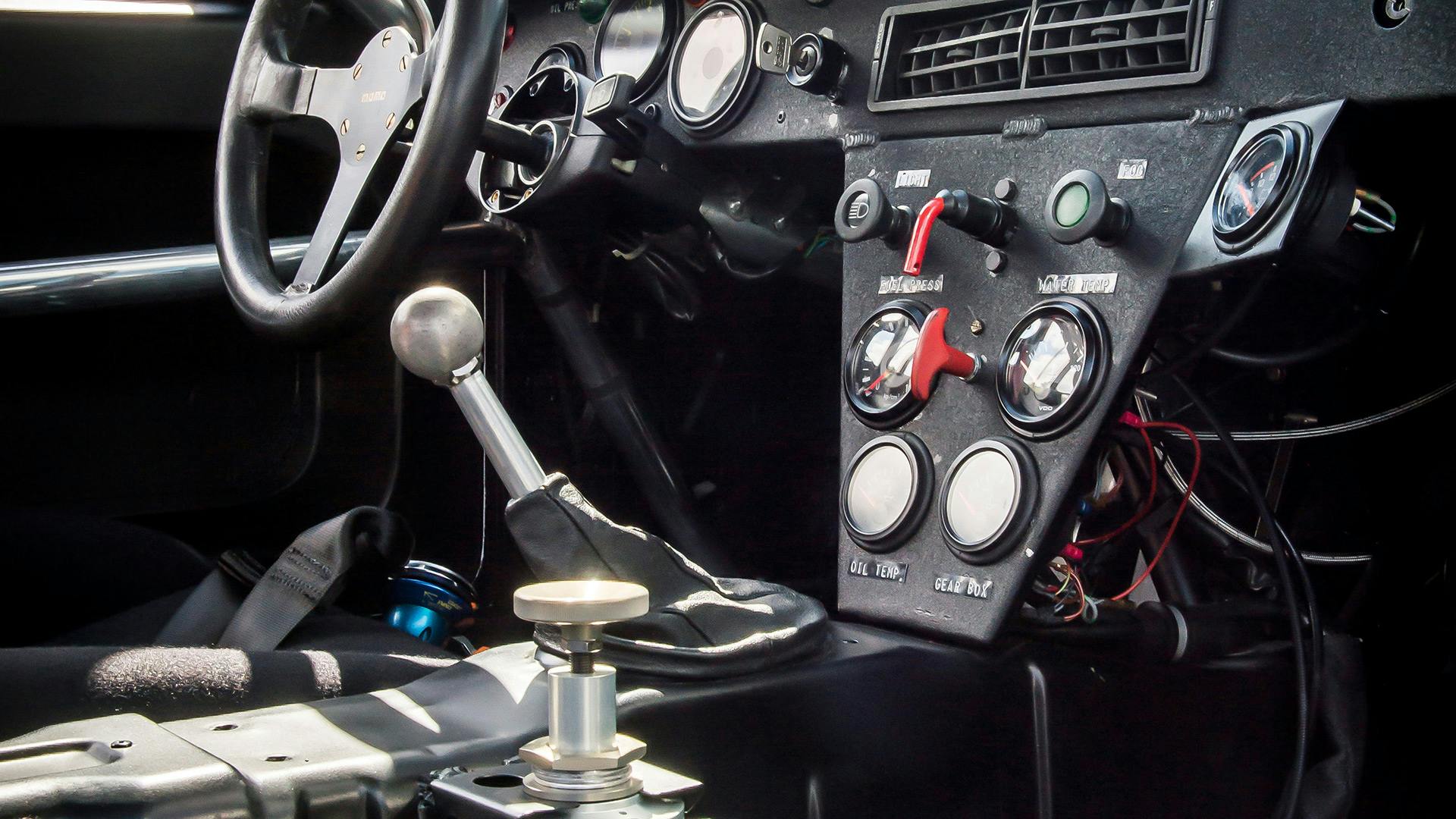 Interior of a Porsche 924 GTP with steering wheel, gear lever and instruments.