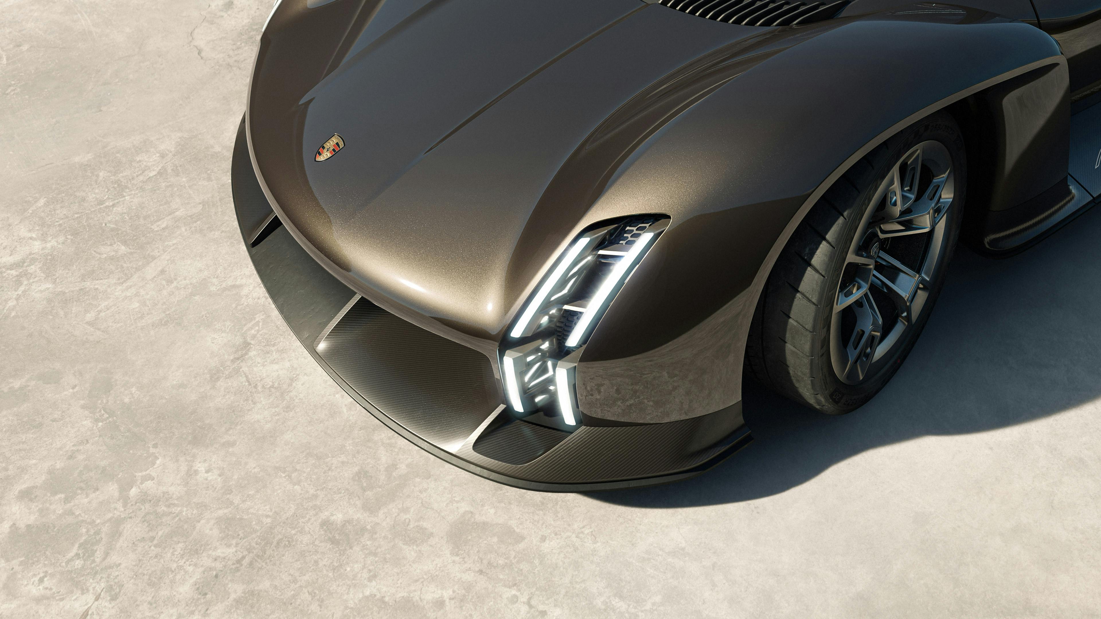 Porsche Mission X de couleur Rocketmetallic. Vue plongeante de l’avant avec zoom sur les phares.