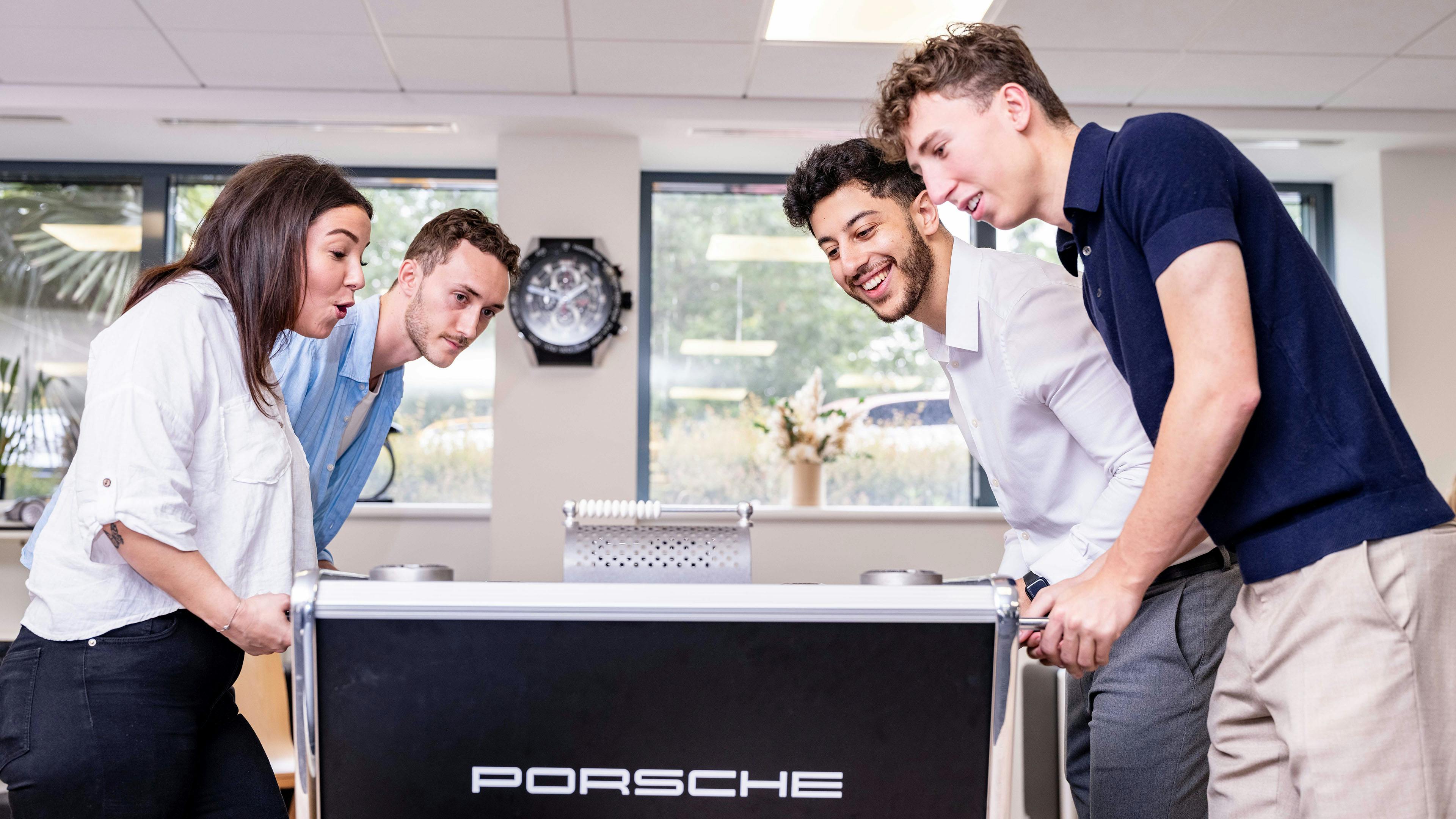 4 people playing tabble soccer.