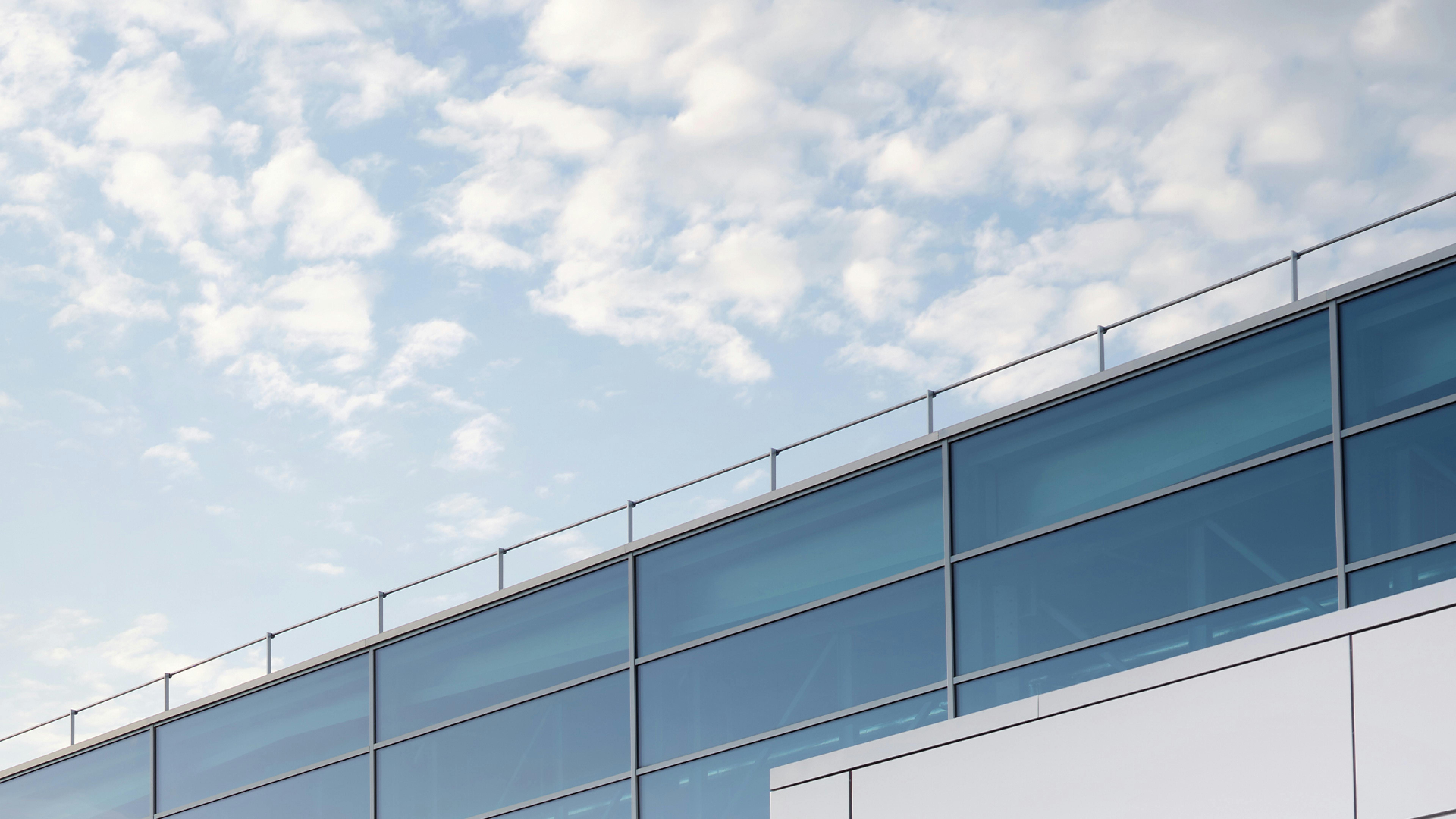Blue sky over a Porsche dealership.