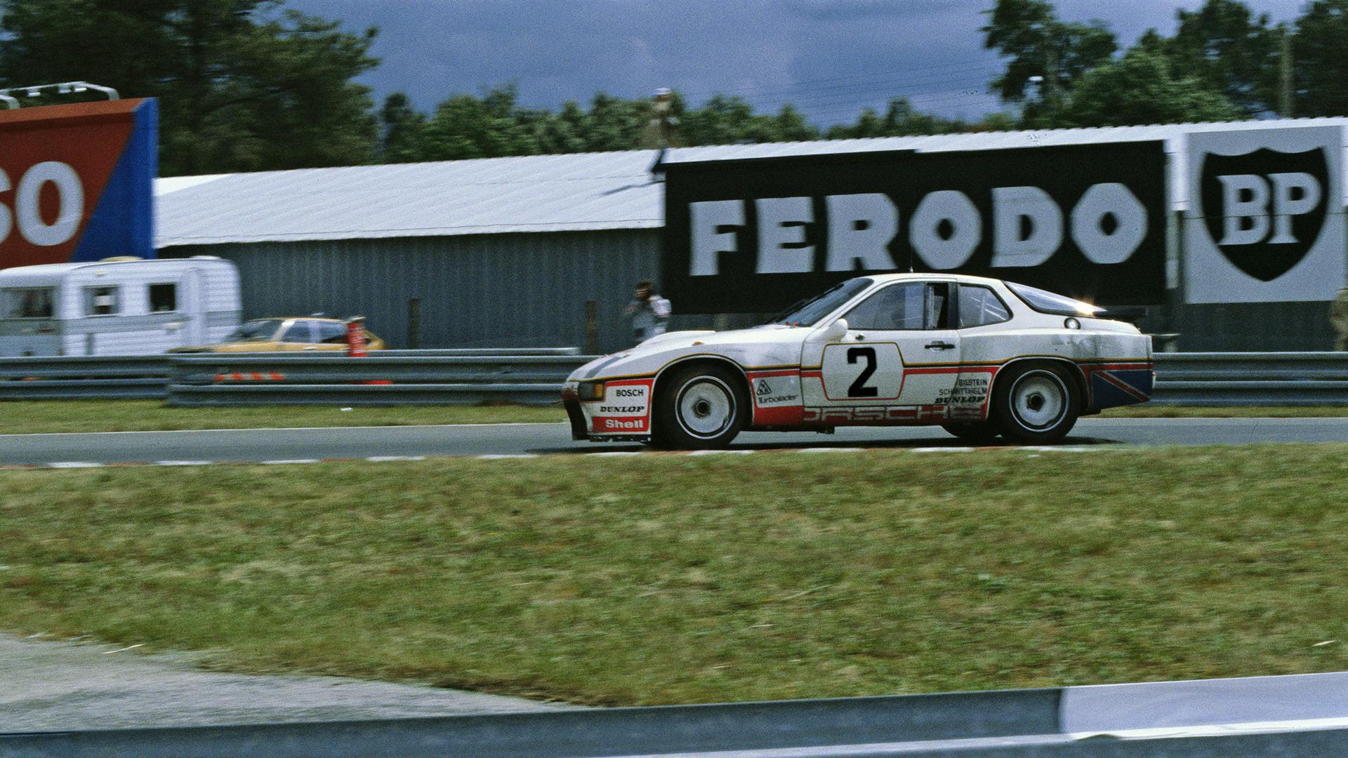 Porsche 924 GTP driving on the race track.