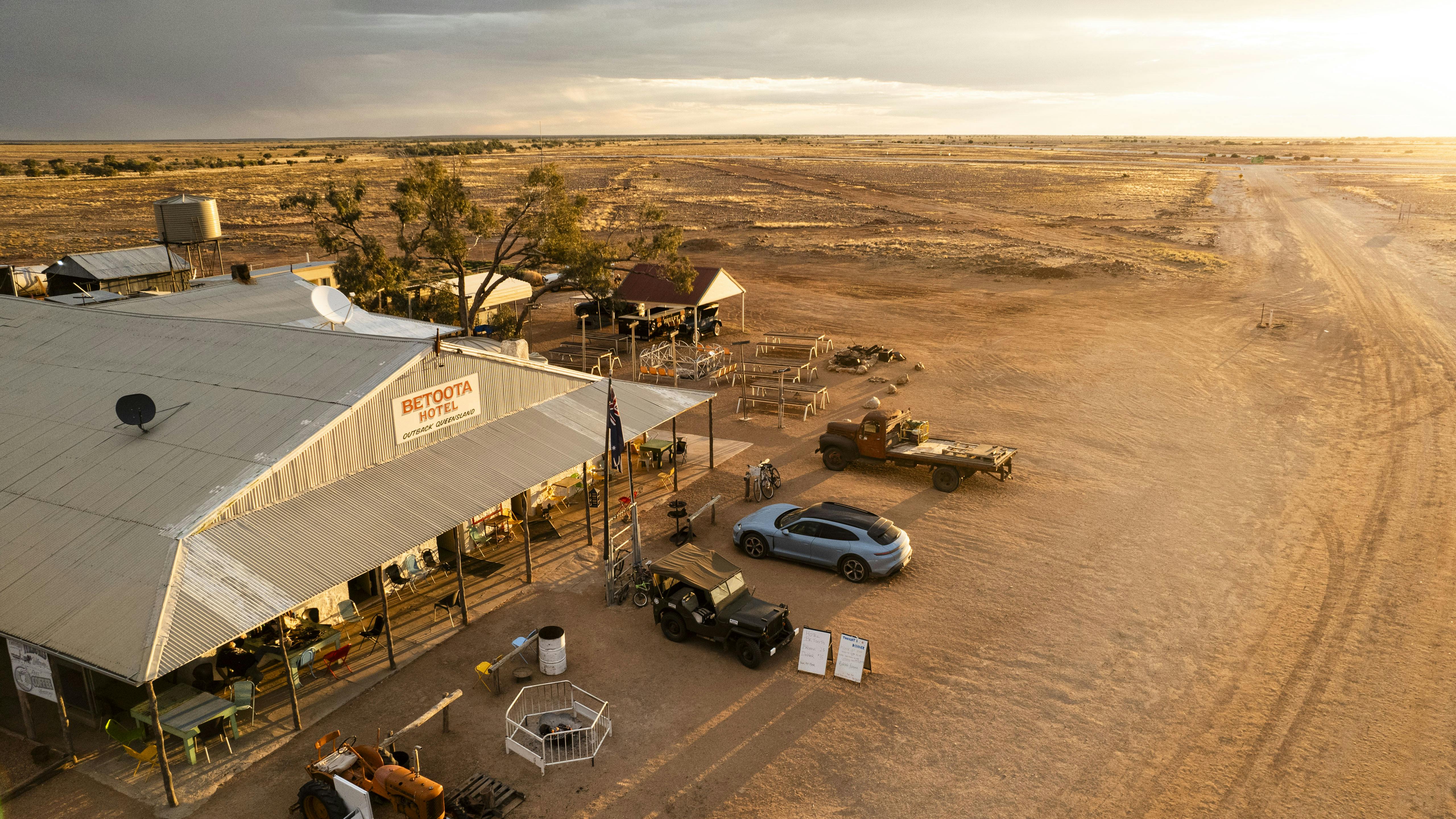 Porsche Taycan Cross Turismo parked outside a remote hotel in the Outback