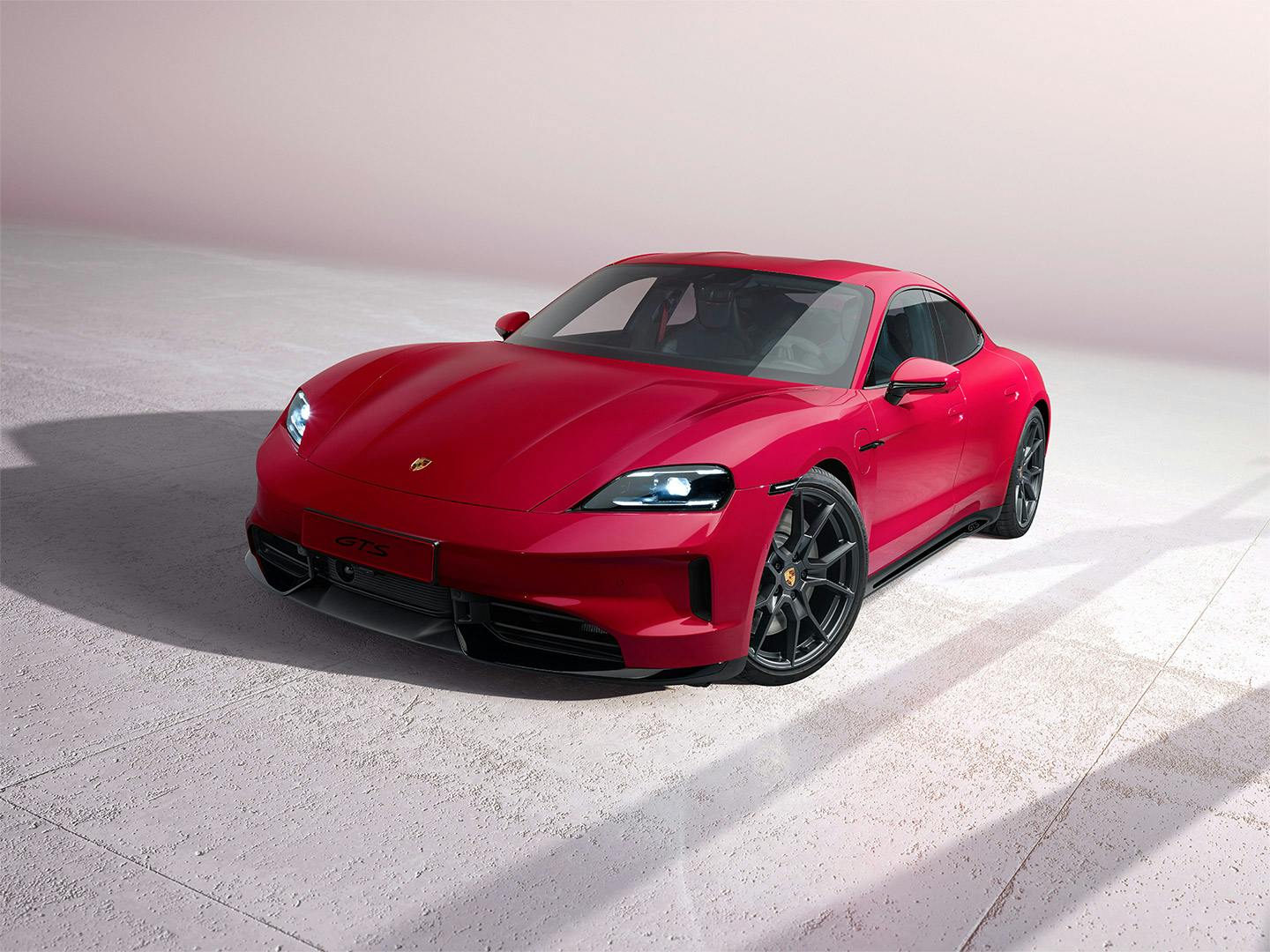 A front view of a red Porsche Taycan GTS.