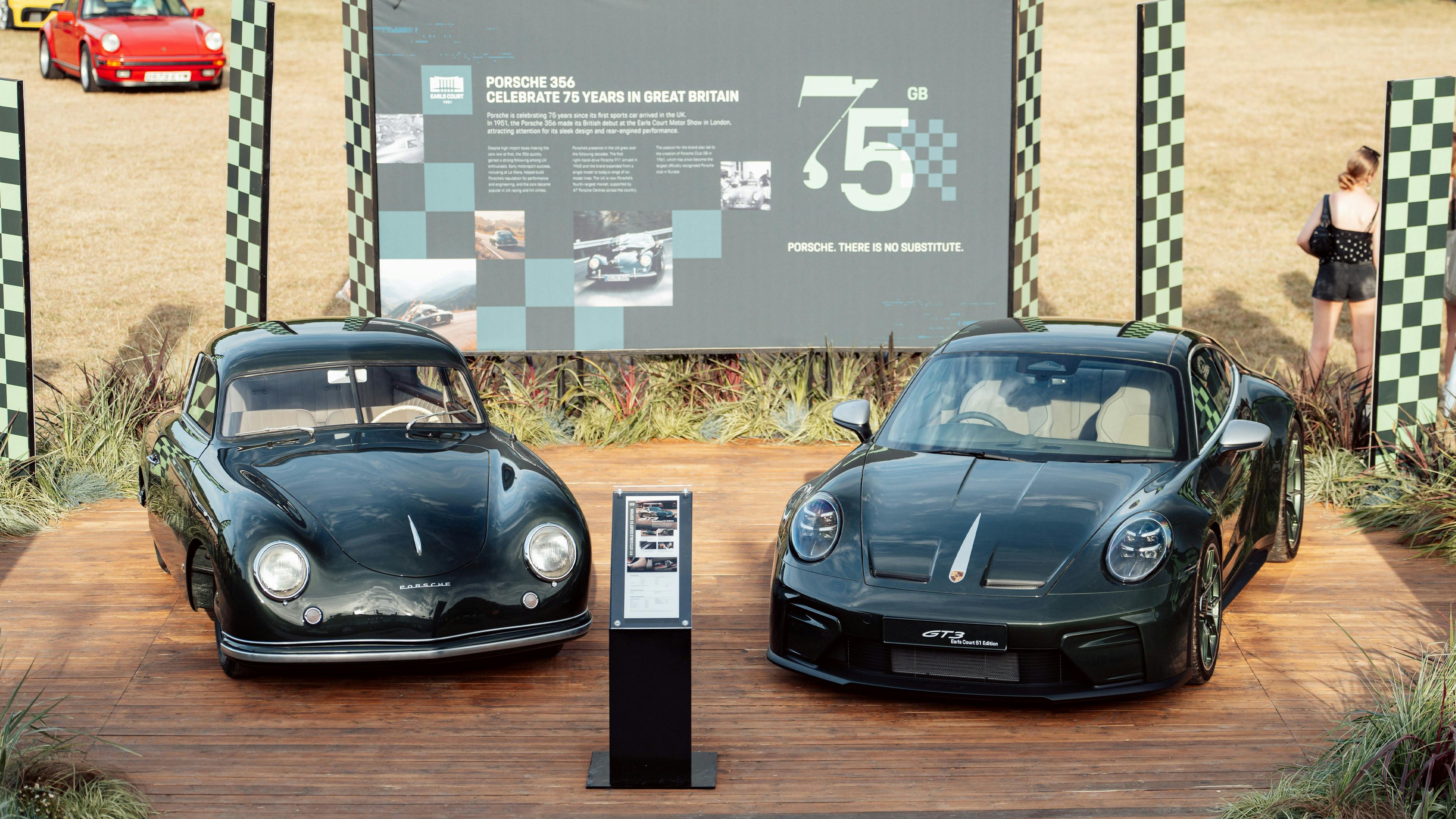 A classic Porsche 356 and a modern 911 displayed side by side on a wooden plinth, with a screen behind marking 75 years of Porsche in Great Britain.