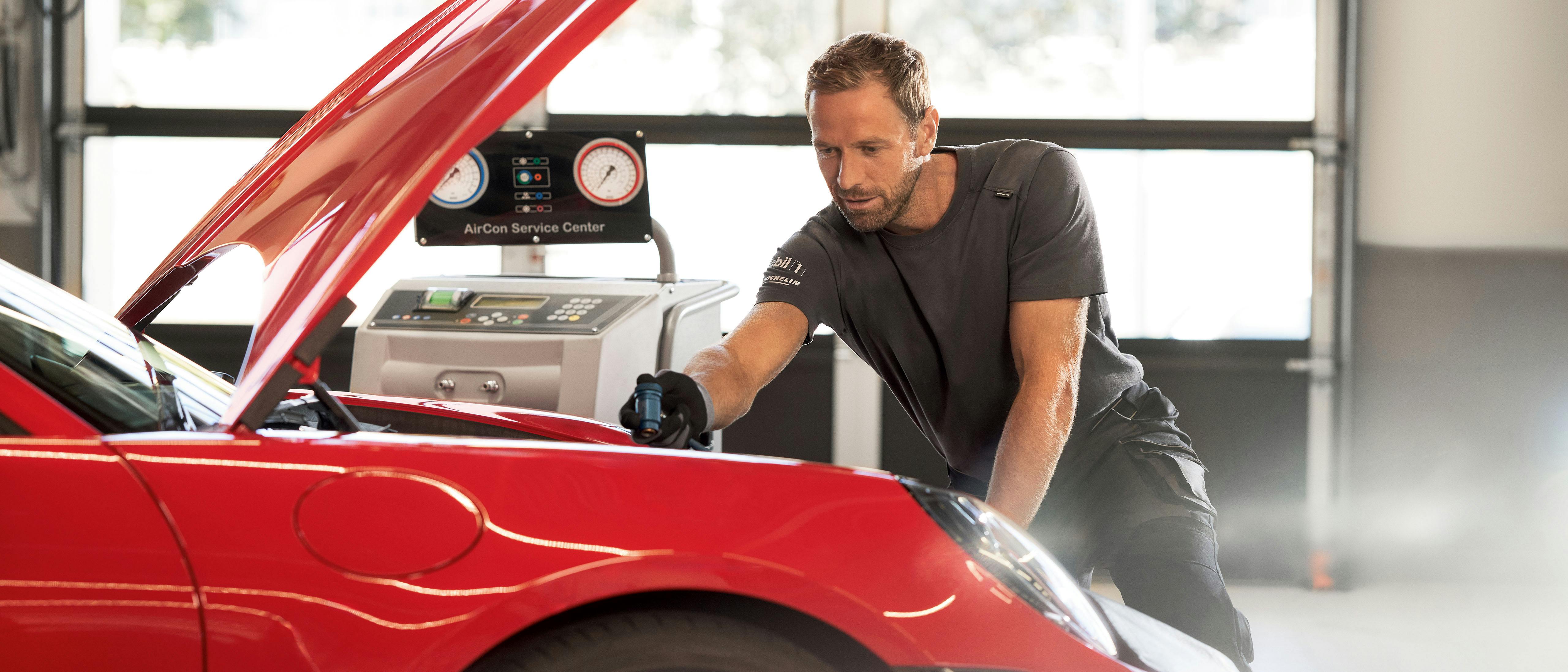 Een Porsche monteur checkt de airco van een Porsche in de werkplaats.