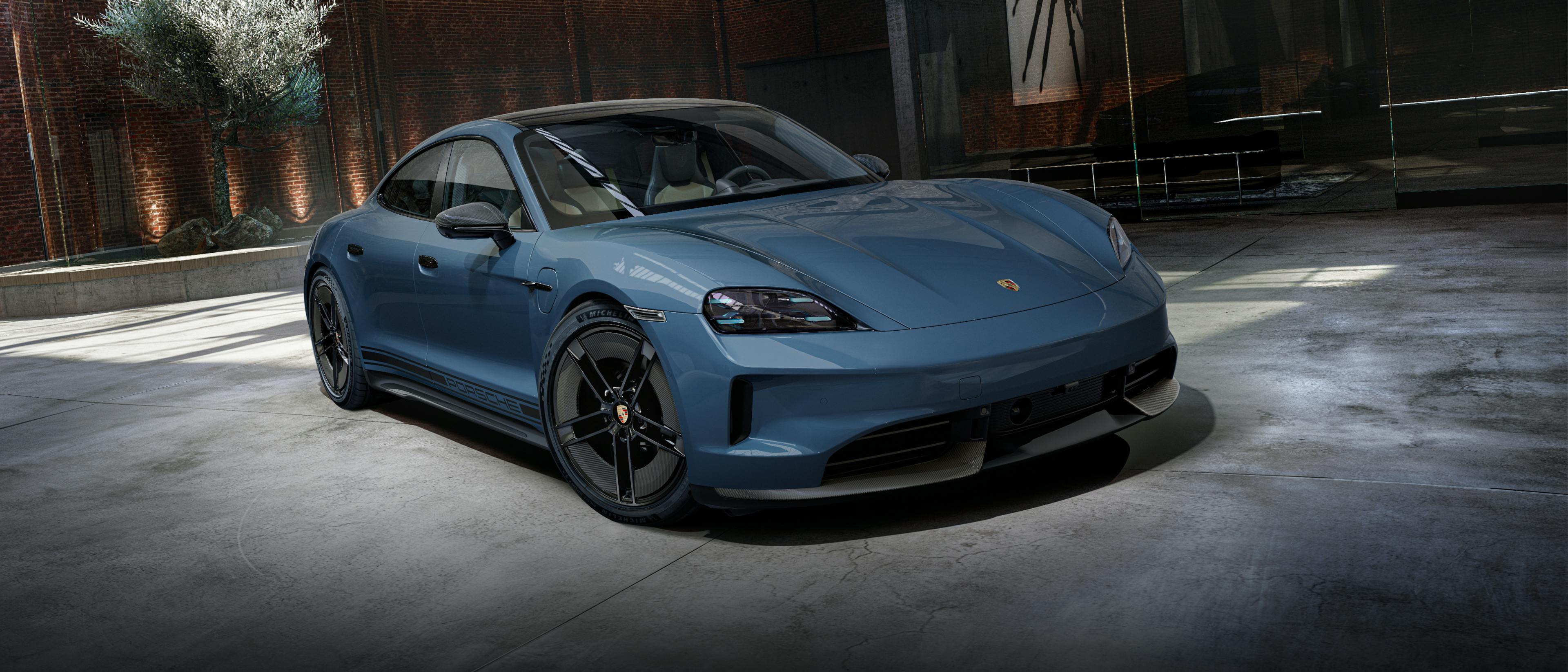 Porsche Exclusive Manufaktur Taycan GTS with SportDesign package Carbon in Pale Blue Metallic. View of the front and side.
