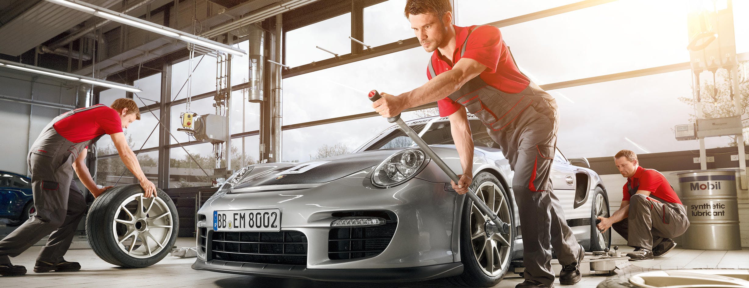 Mechanichs working on silver car