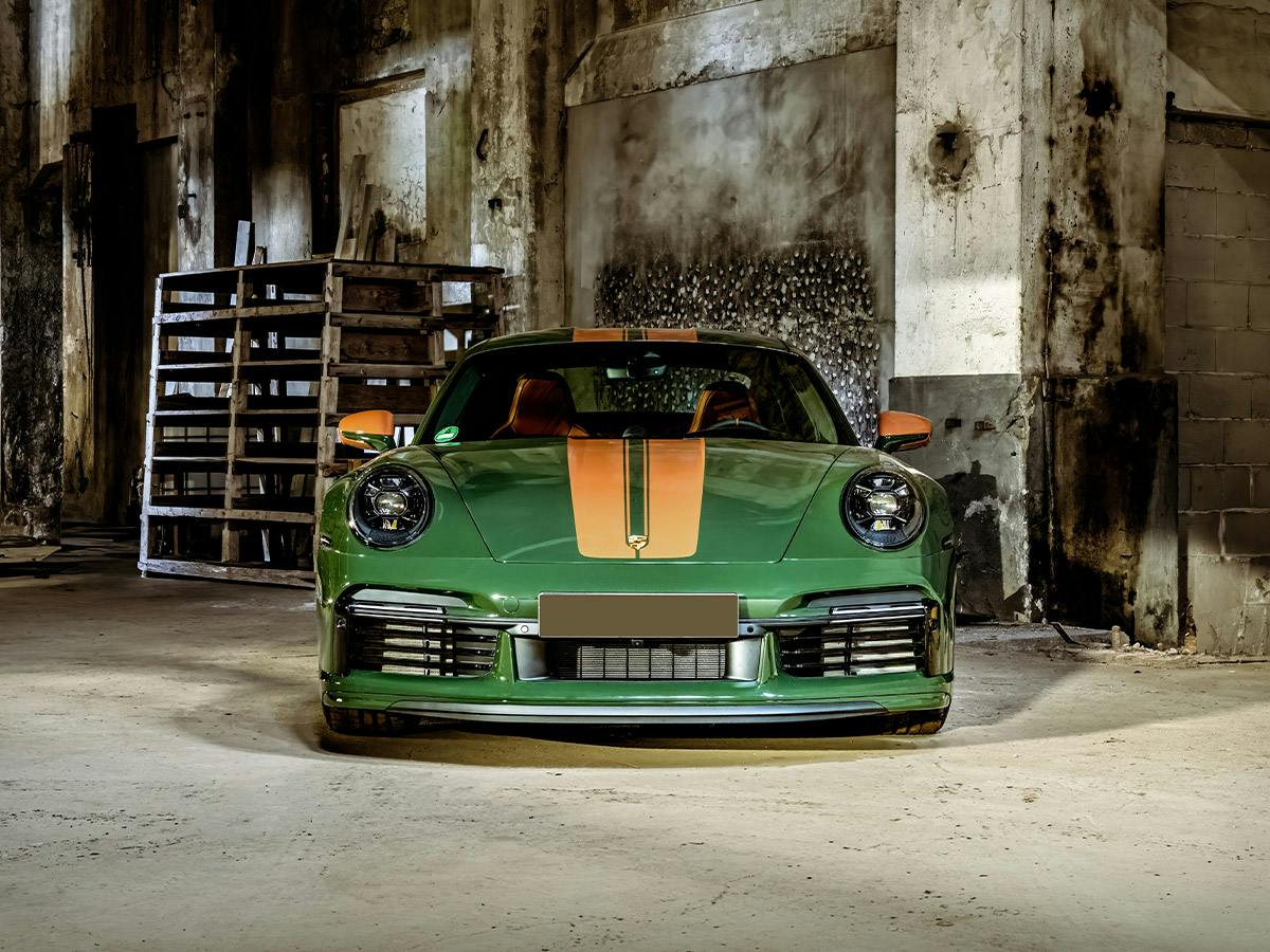 A 911 Sport Classic coloured in Underberggreen with Stripes and rear mirror in Sepiabrown from the front in an old paper mill.