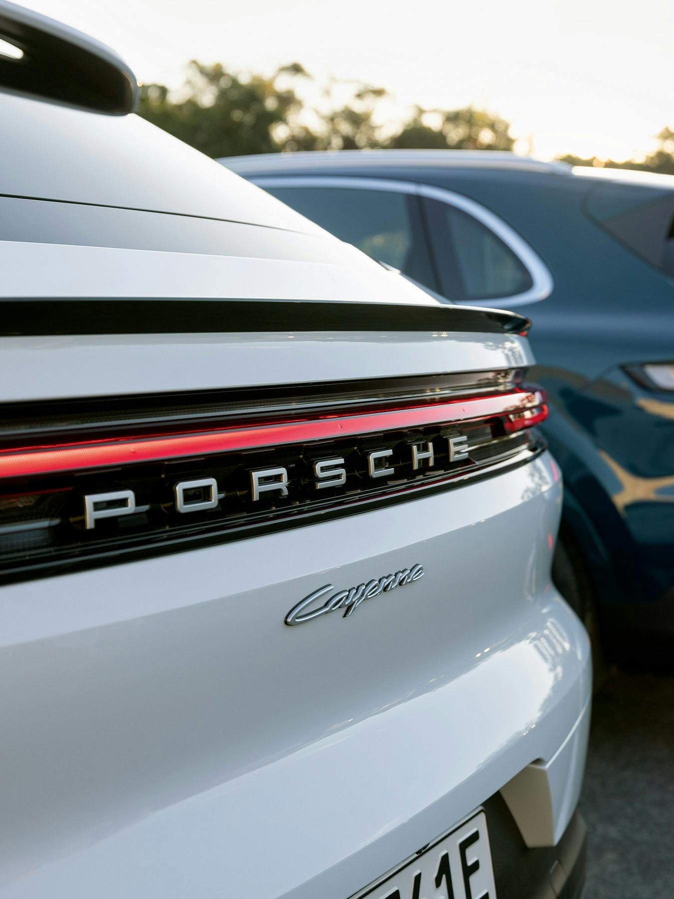 Macan Electric and Macan Electric 4S driving in the sunset.